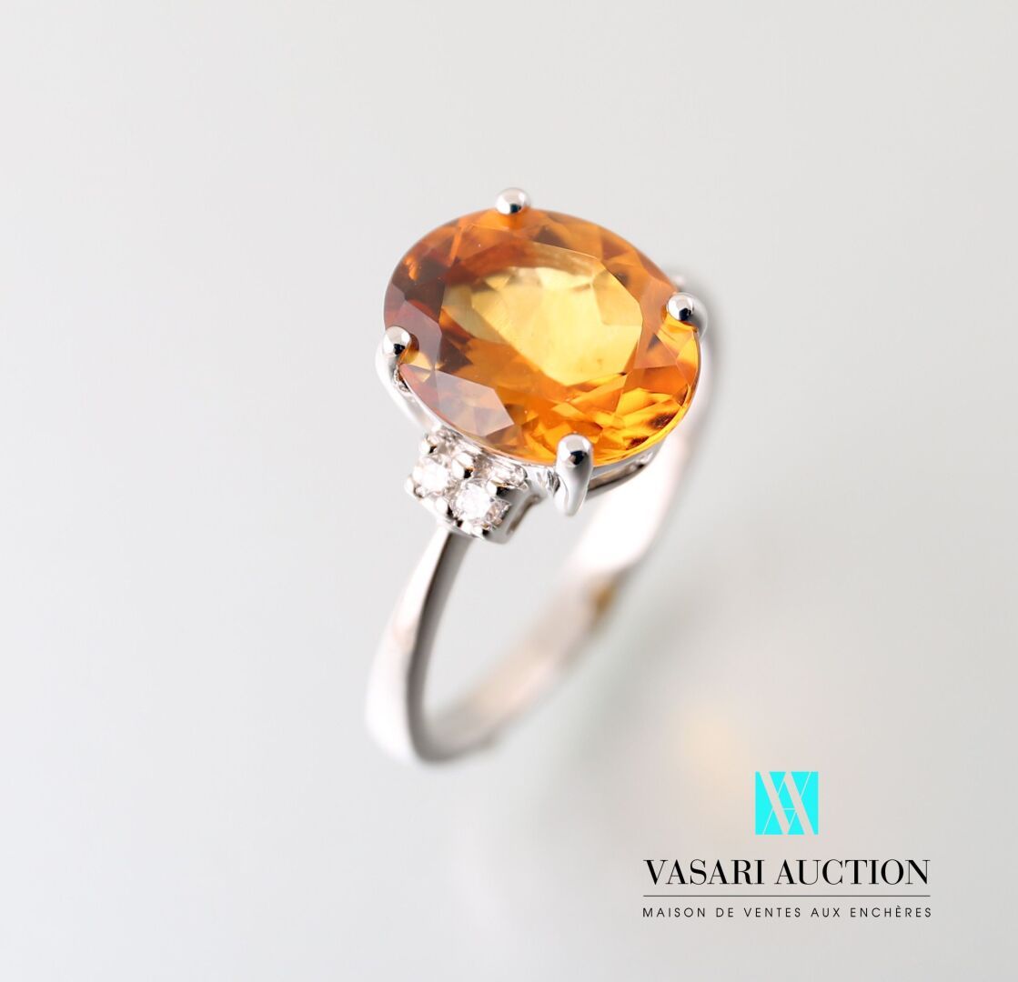 Null 750千分之一的白金戒指，装饰着一个大约3克拉的椭圆形黄水晶，由四颗现代尺寸的圆钻支撑。

毛重：3.77克 - 手指尺寸：53