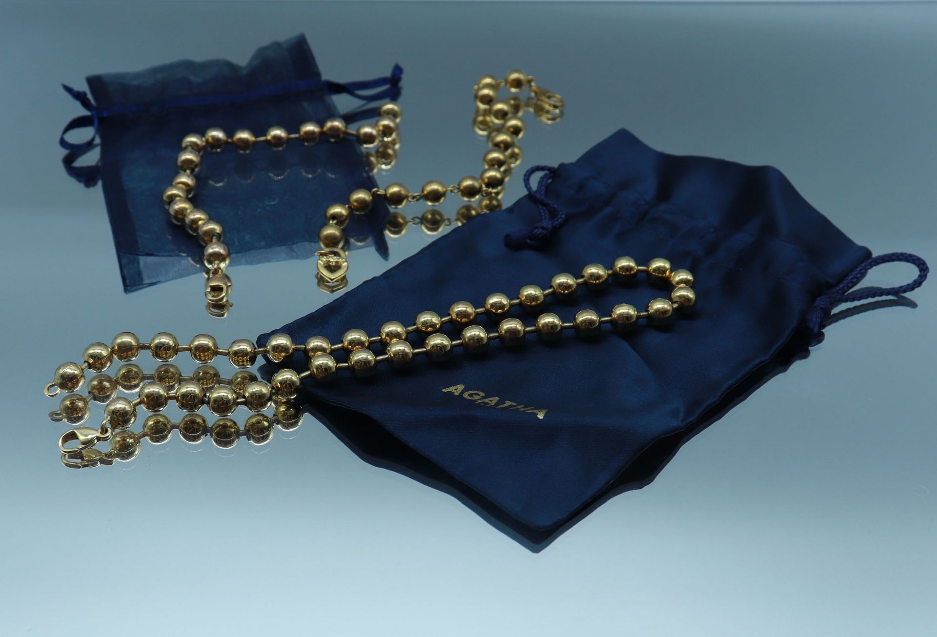 Null AGATHA Paris 

Lot including two bracelets and a necklace made of golden me&hellip;