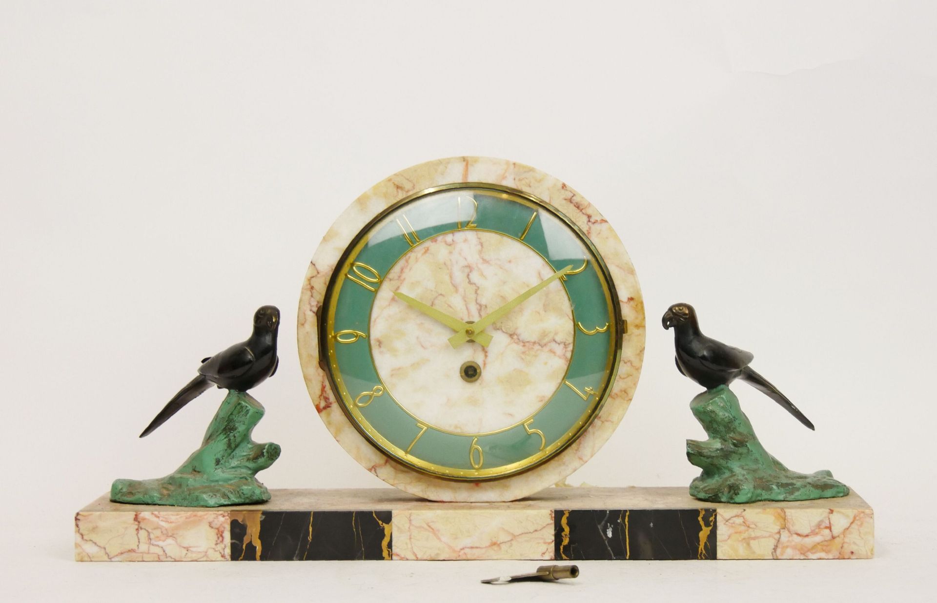 Null 粉色和黑色大理石脉络的鹦鹉圆形钟，绿色珐琅的表盘，金色的阿拉伯数字，由两个代表鹦鹉的雕塑支撑。DUVERDREY & BLOQUEL运动

1930年&hellip;