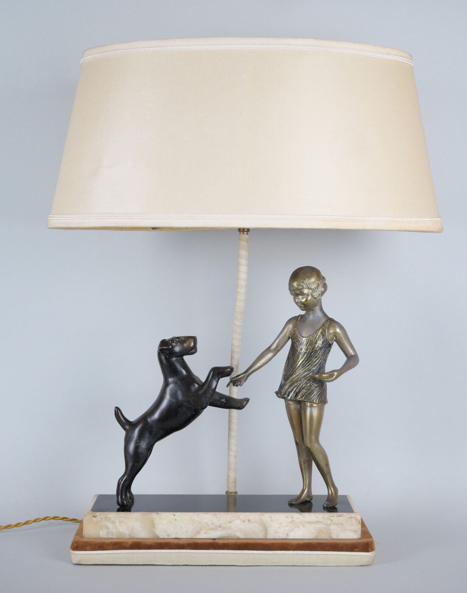 Null Sculpture in two-tone regula representing a young girl training her dog, re&hellip;