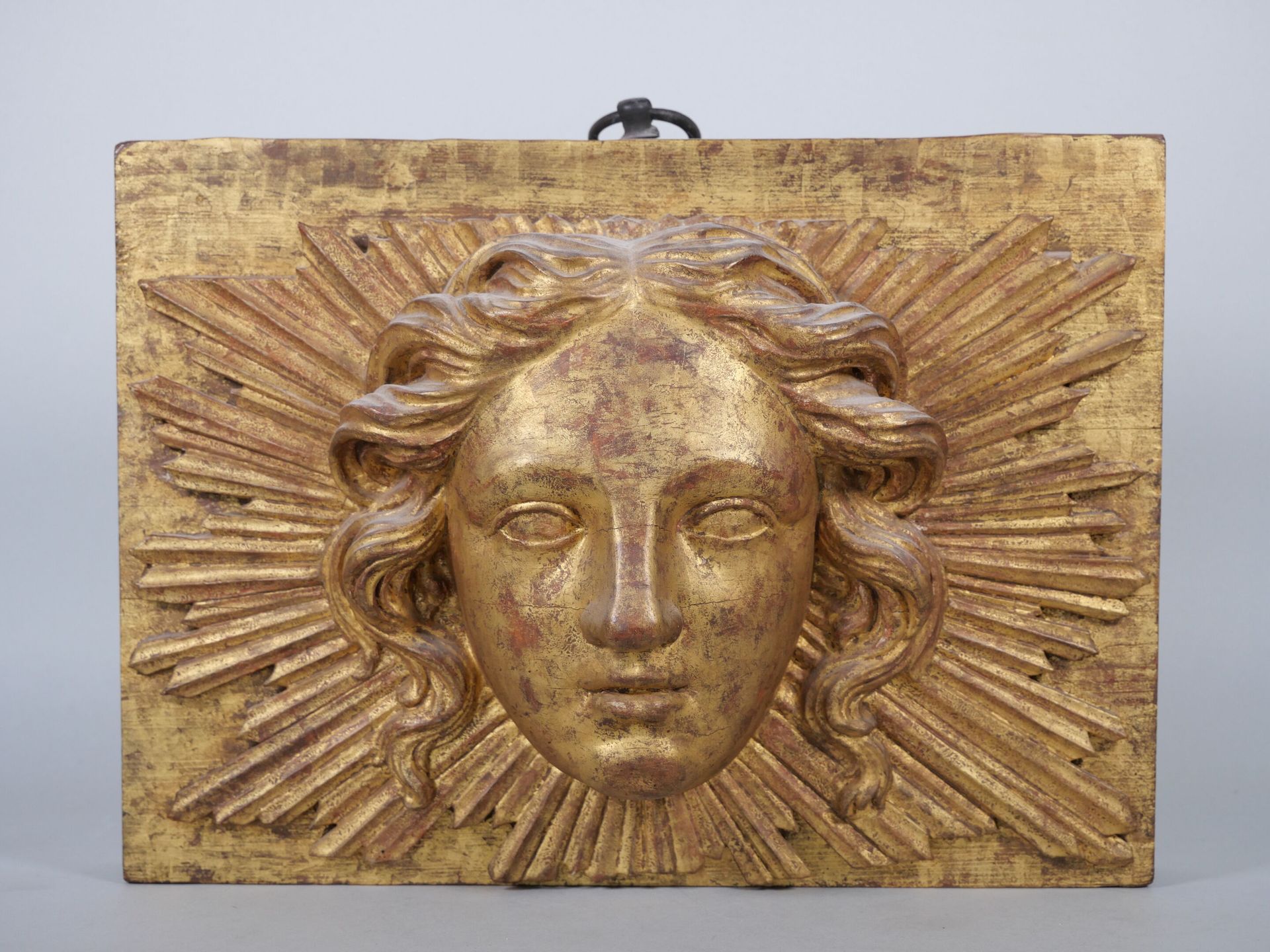 Null 雕刻和镀金的木质装饰板，描绘了一个半圆形的波浪形头发的女性头像，应用于辐射状的梁。加了支撑。 
尺寸：22 x 30厘米。 

专家：MB ART E&hellip;