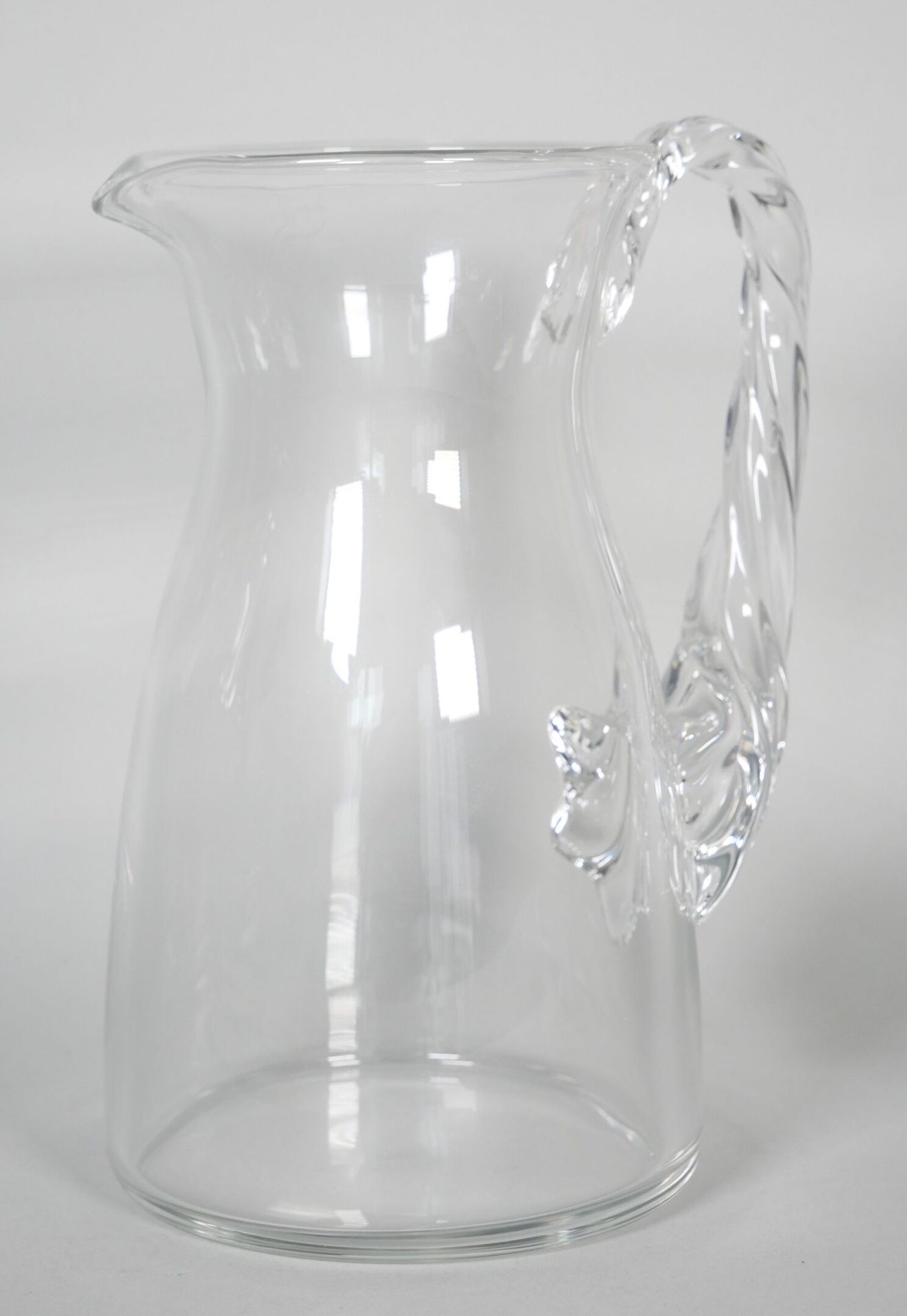 Null LALIQUE France. 
Crystal orangeade pitcher with turned handle. Signed under&hellip;