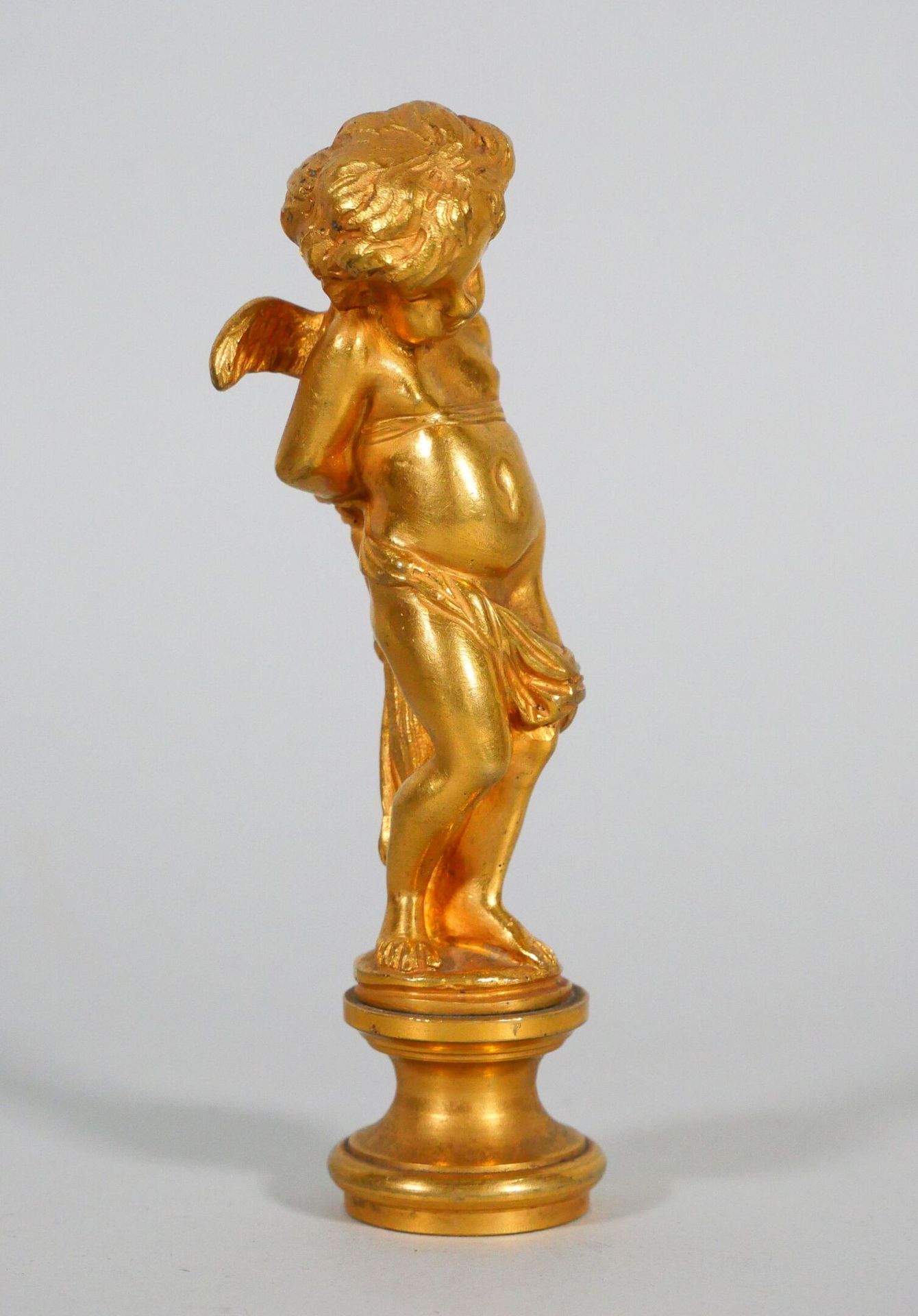 Null Gilded bronze seal depicting a cherub, hands bound by a drape. 
Late 19th c&hellip;