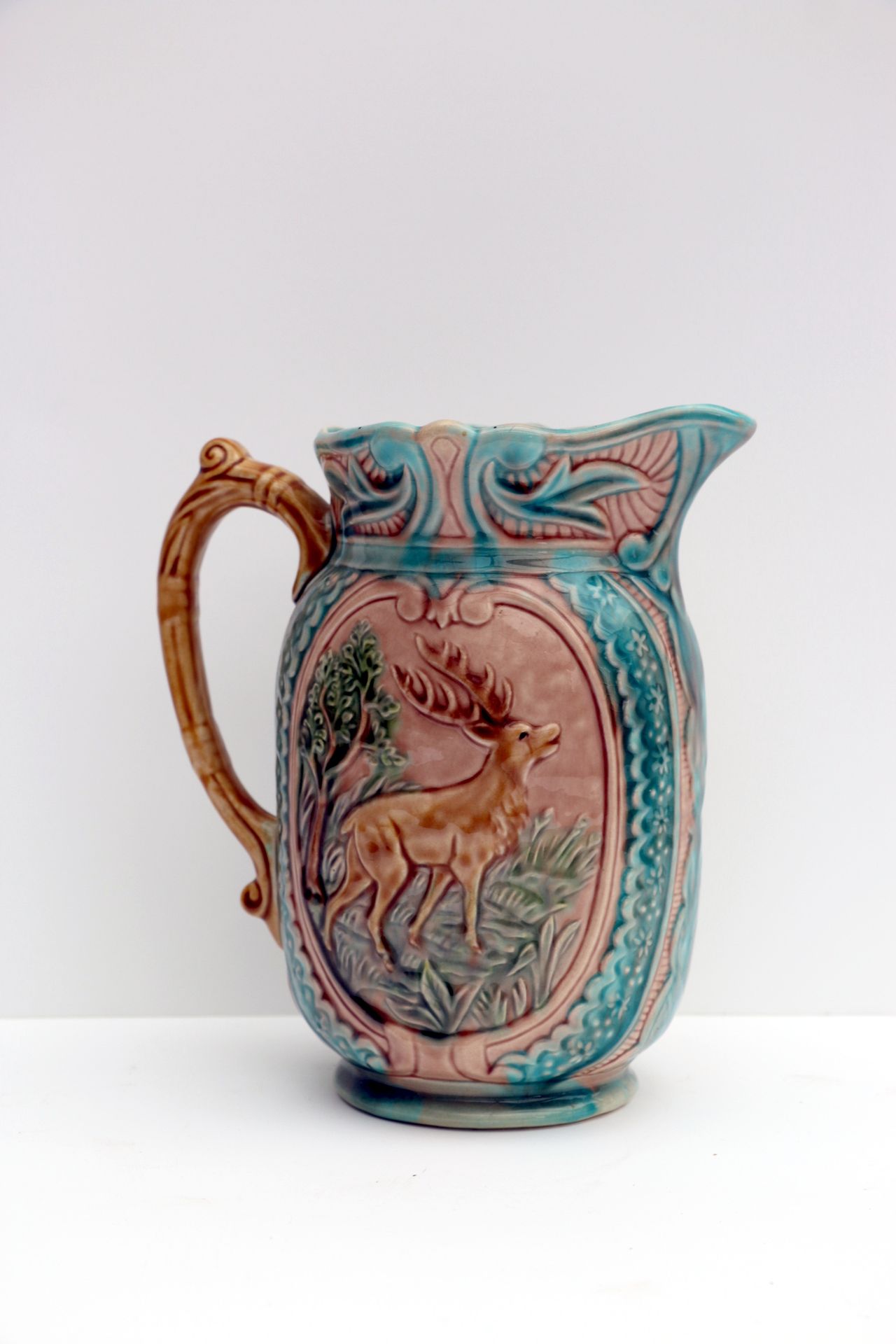 Null Pitcher with handle in barbotine, decorated with a stag and a doe. H 21 cm