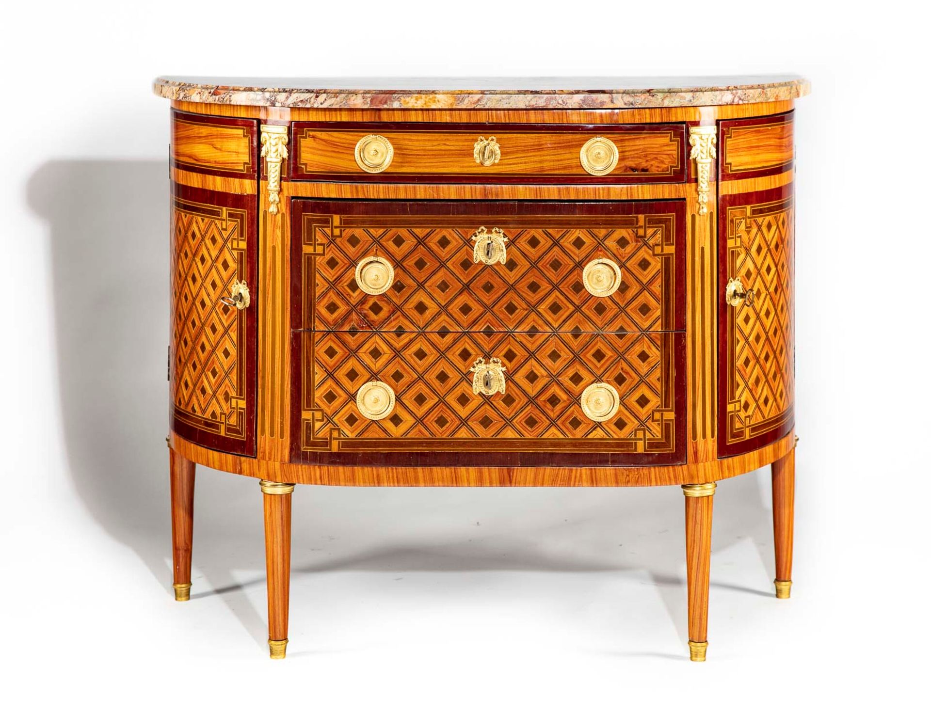 Null 
A half-moon shaped geometrical marquetry chest of drawers, opening to thre&hellip;