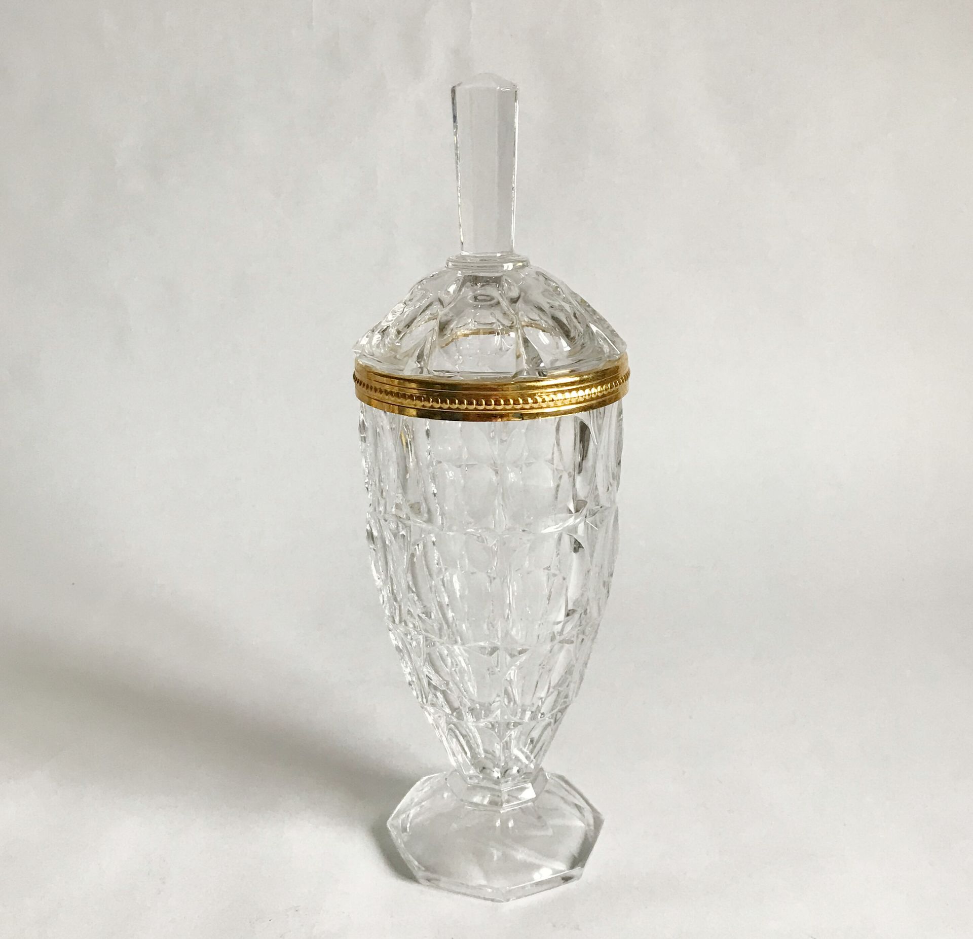 Drageoir couvert en verre facetté et bordure en métal doré. 
H. : 28 cm