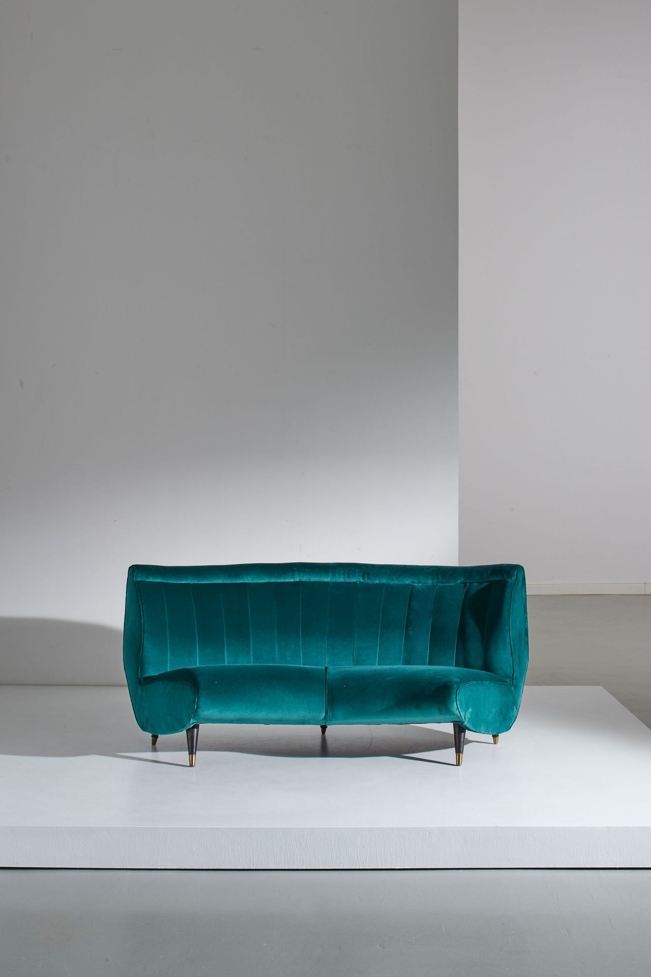 G. VERONESI Curved sofa. Ebonized wood, brass, upholstered fabric. Production I.&hellip;
