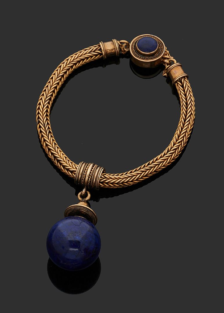 Null 750千分之一的黄金弹性手镯，编织的链节上挂着一个有色的青金石移动球。
19世纪的罗马作品。
毛重：56,6 g
有一个成型的箱子。