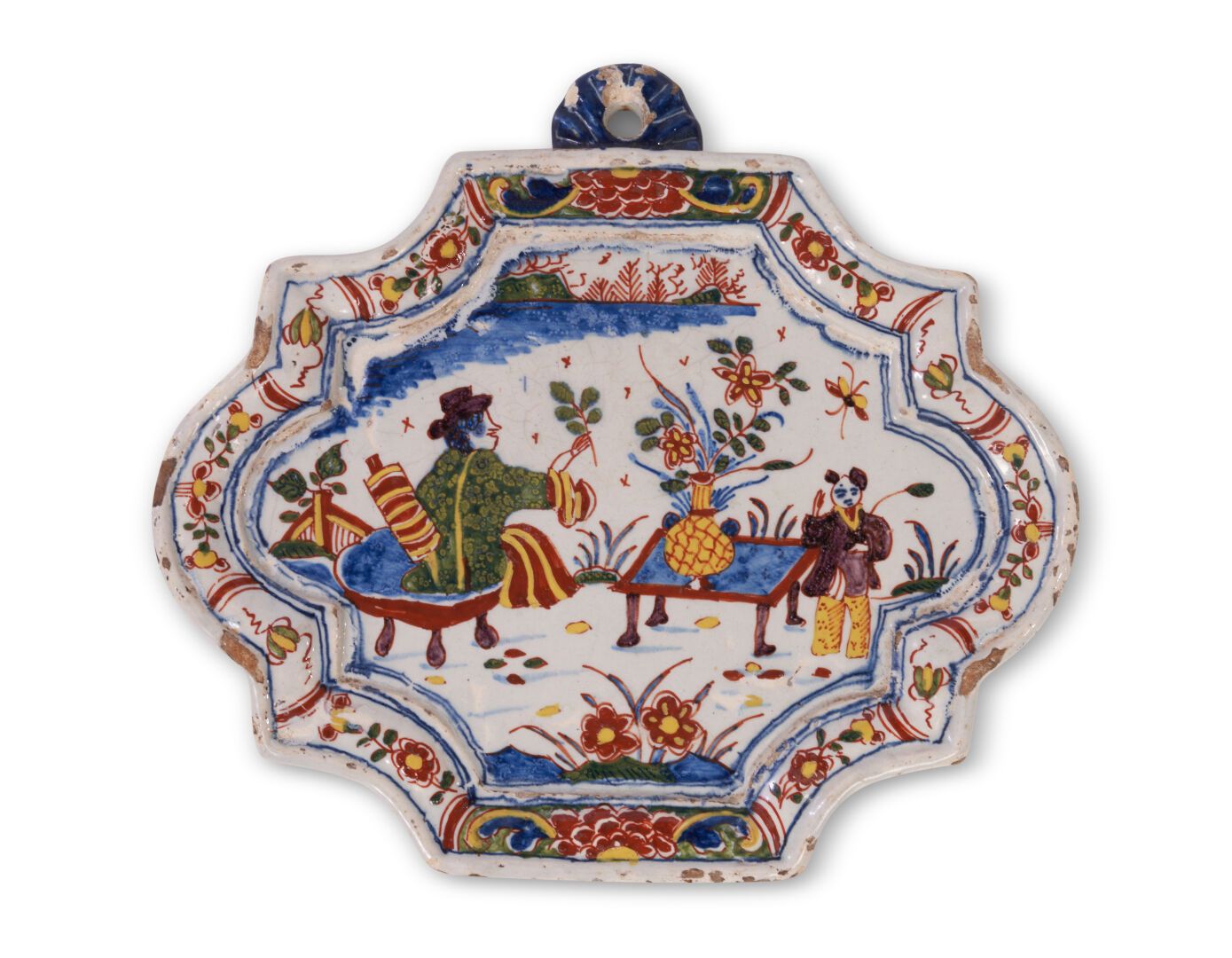 Null 代尔夫特
一个椭圆形的陶盘，有一个轮廓的边缘，上面有多色的装饰，两个中国人靠近桌子上的花瓶，边缘上有花的边框。
18世纪。 
L. 24,5 cm x&hellip;