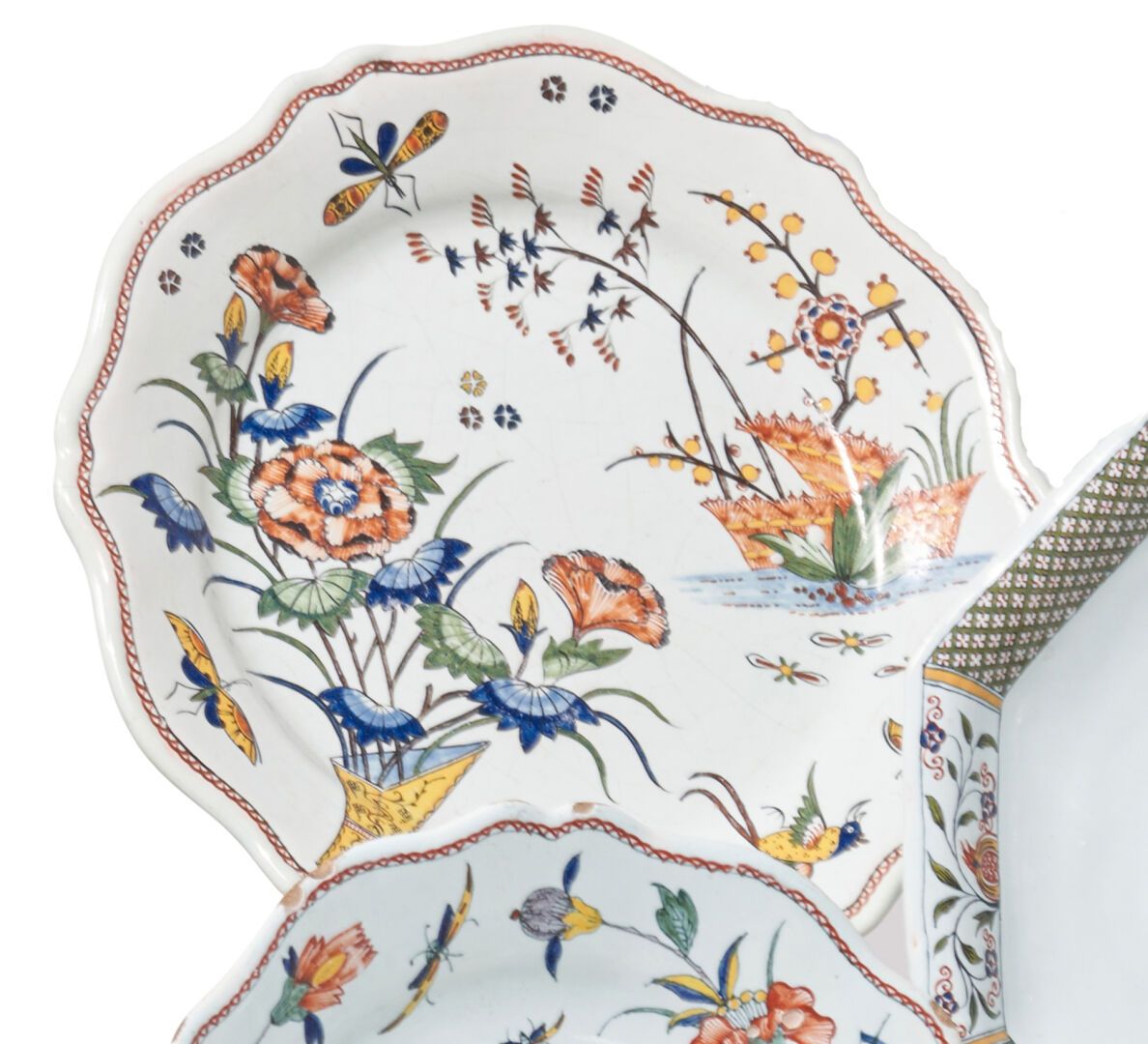 Null 鲁昂
一个陶器盘，上面有一个截断的角的多色装饰，上面有花朵、树篱、梅花、鸟和蝴蝶。
18世纪。 
D. 25厘米。
一个芯片。