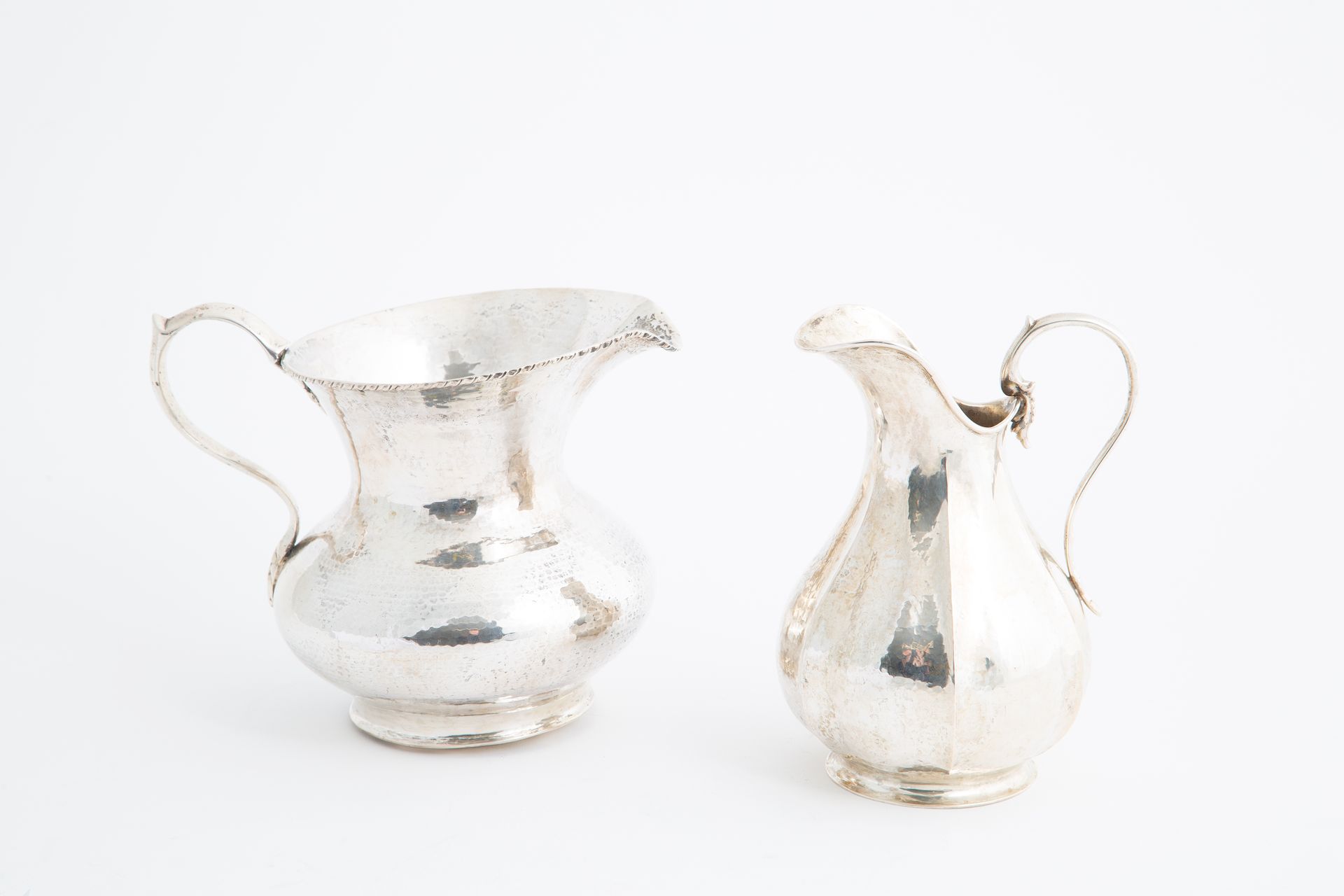 Two 800 silver pourers, gr. 980 ca. 20th c. Two poursers in embossed 800 silver,&hellip;