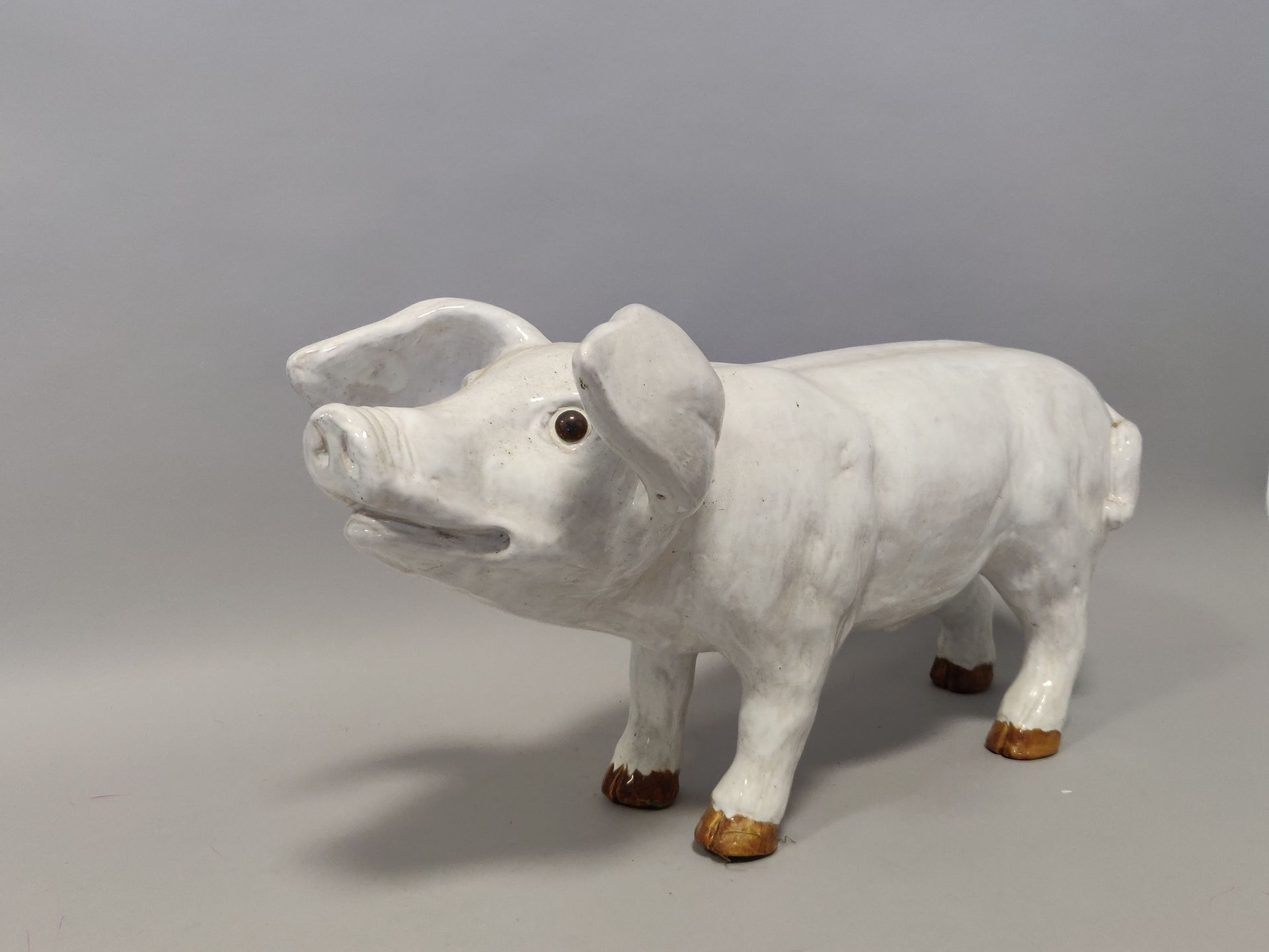 Null BAVENT. White glazed terracotta subject representing a pig. The eyes in sul&hellip;