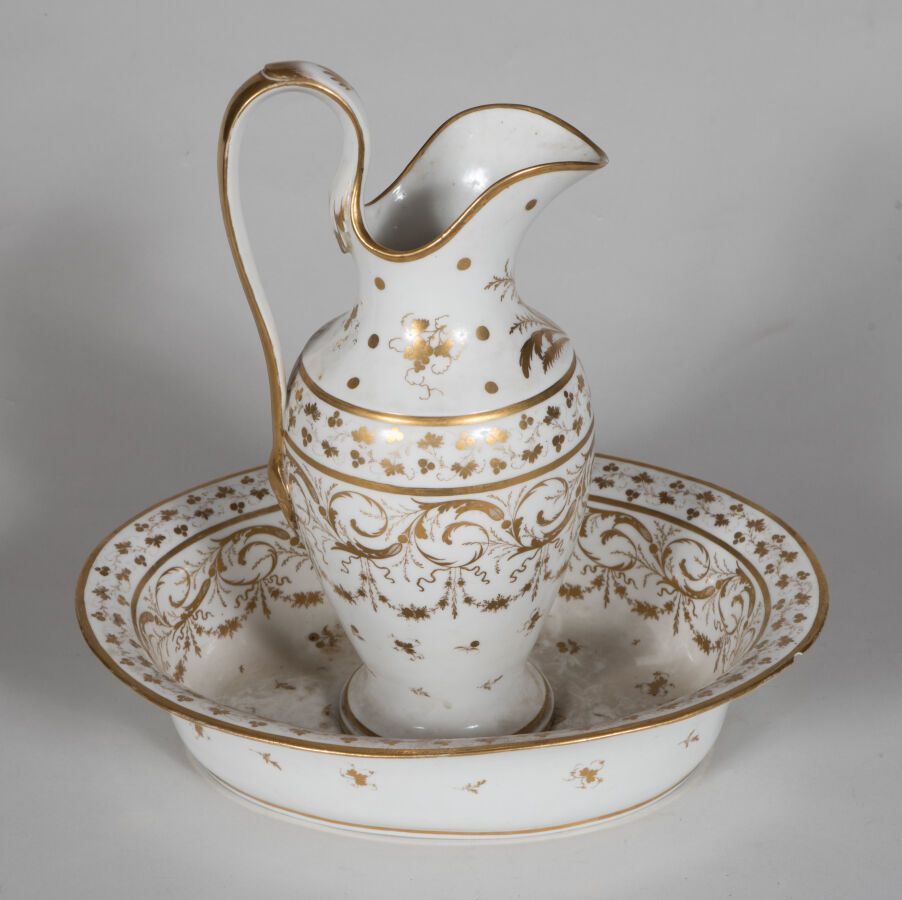 Null PARIS.

Pot à eau et son bassin ovale en porcelaine à décor en or de guirla&hellip;