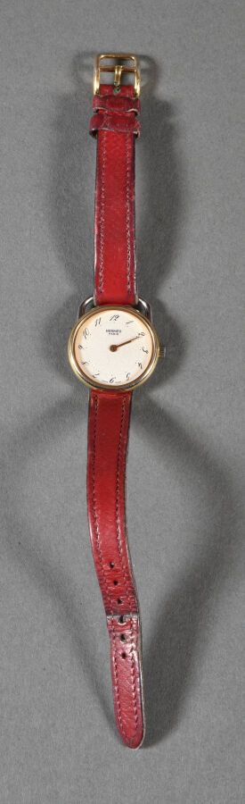 Null HERMES Paris. Gold-plated and silvered metal Arceau watch, white background&hellip;