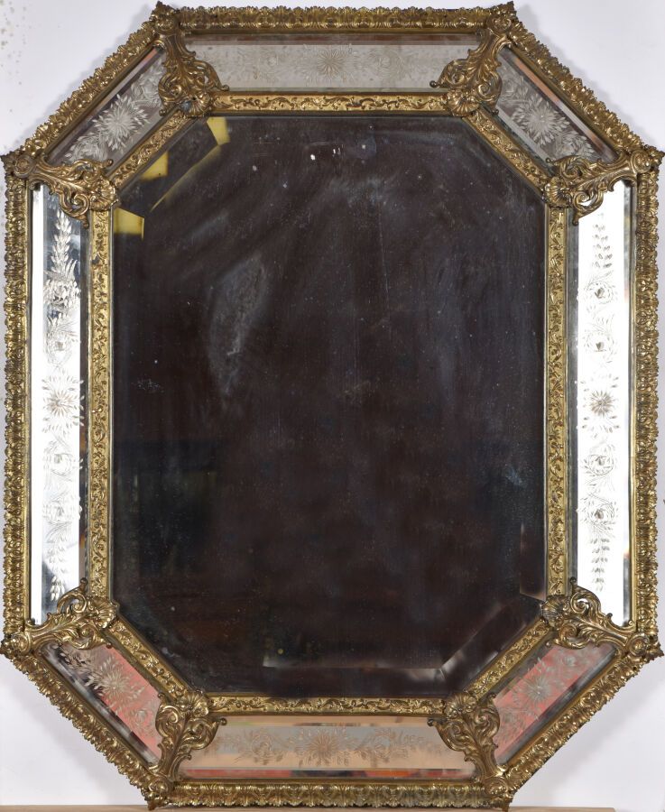 Null 路易十四风格的镜子，具有倒置的轮廓，由刻有花朵的镜子储备组成，在一个铜制的叶子扣框架中。 
19世纪。 
H.83 cm - W. 69 cm
损坏。