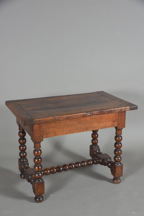 Null 胡桃木桌子，表面有铜锈处理，H型腿和支架变成了念珠，顶部有侧缝。 
里昂作品。17世纪末，18世纪初。 
H.72厘米 - 宽97厘米 - 深60厘米&hellip;