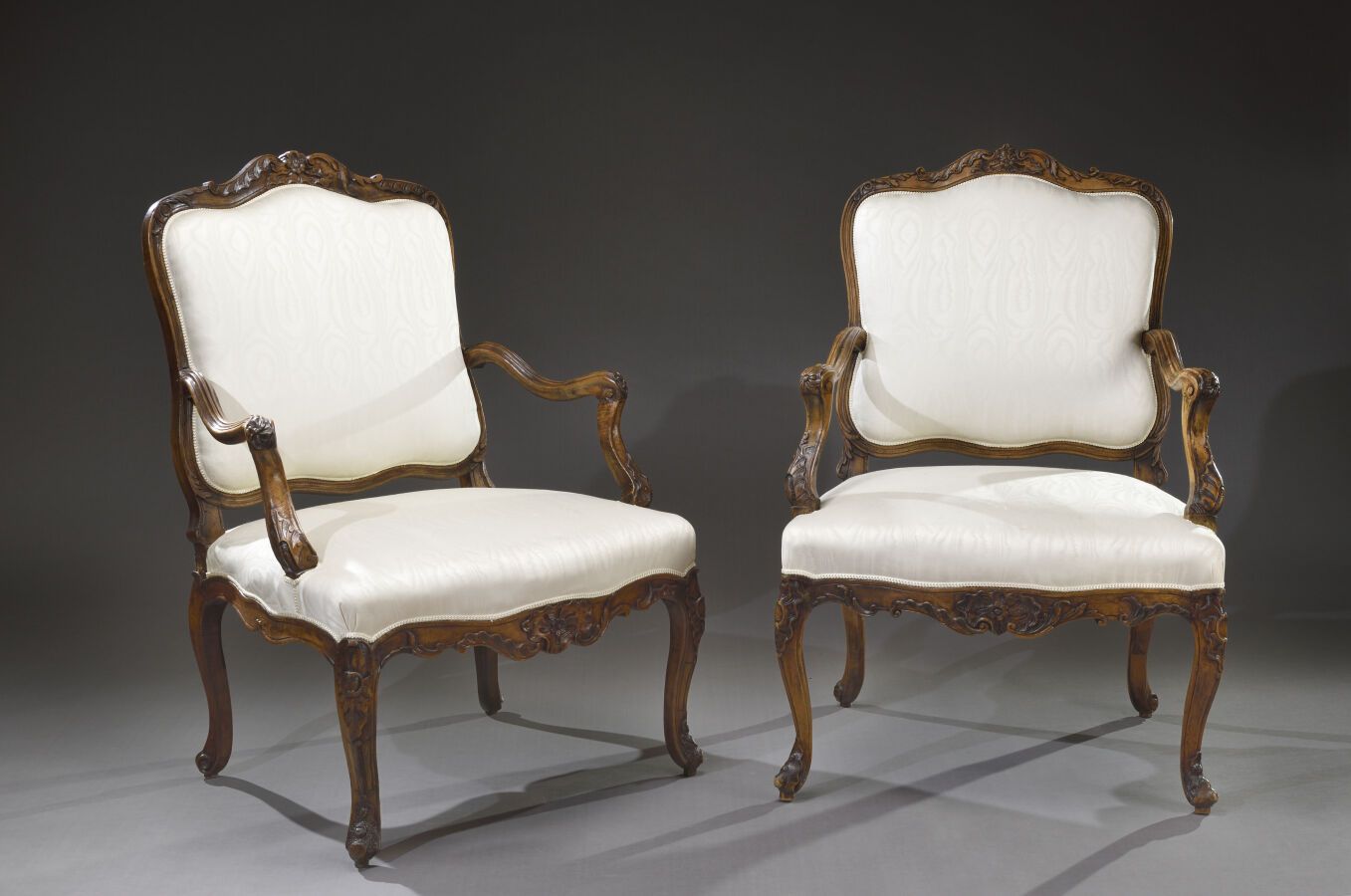 Null Two patinated walnut "fauteuils à la reine en pendant", carved with foliage&hellip;