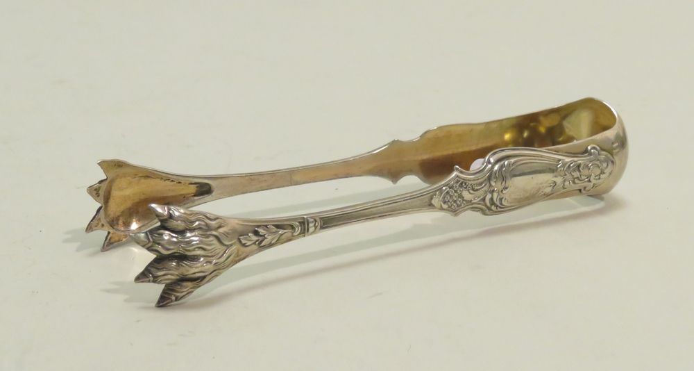 Null 银制糖钳（Minerva标记，标题难以辨认），装饰有卷叶，钳子由狮子的爪子组成。净重：39克35。12.5 x 4厘米。