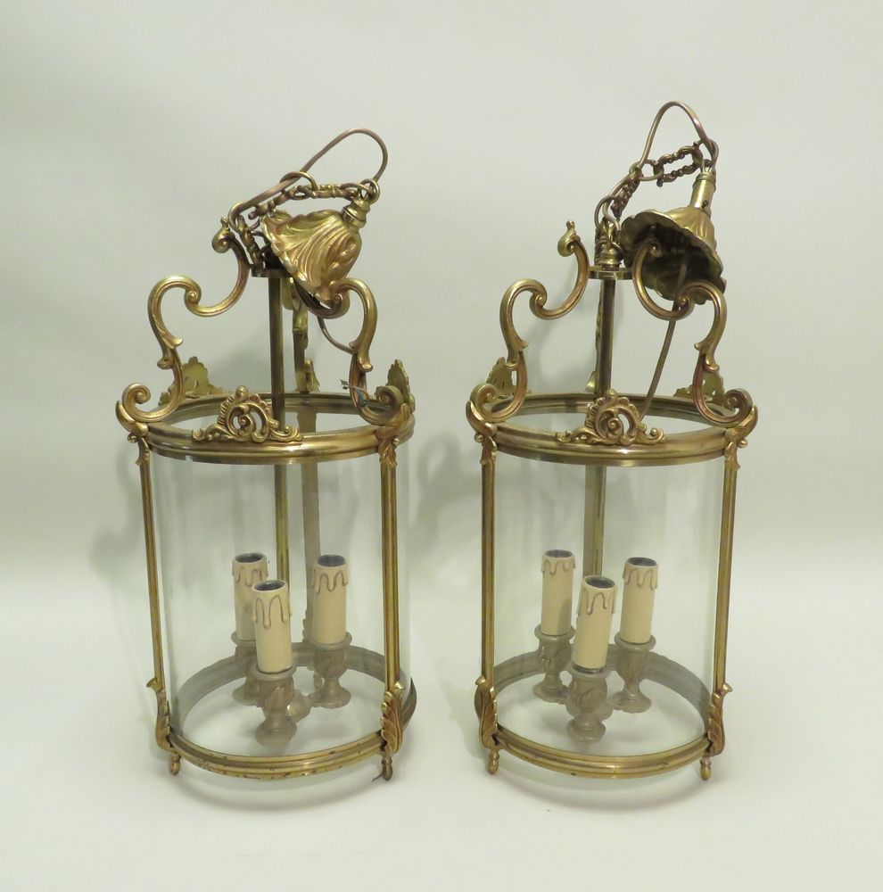 Null A pair of brass and glass three lights lanterns. Xth century. 69 x 23 cm.