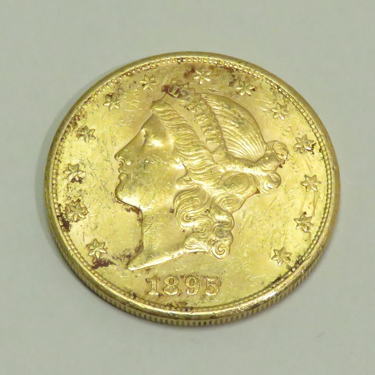 Null 20美元金币 "自由头-双鹰"，日期为1895年，工坊 "S"（旧金山），雕刻师：James B.朗克尔。重量：33克45。直径：34毫米。