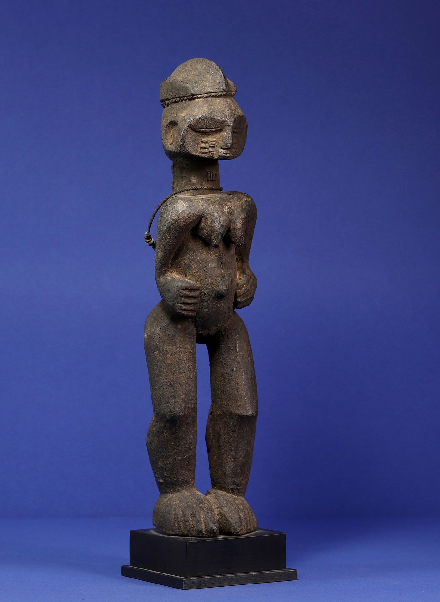 Null 
代表女性形象的有趣雕像，高大有力的双腿，手臂弯曲在短小的躯干上，背部、颈部和面部都有疤痕，头骨上面放着一个四面的小头饰。 



木头上有厚厚的黑色&hellip;