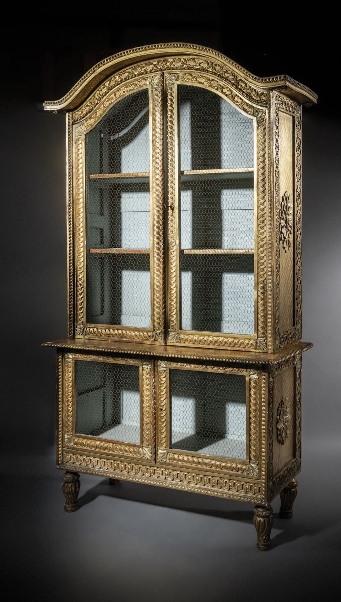 Null Two-part bookcase in carved and gilded wood, opening to four grilled doors.&hellip;