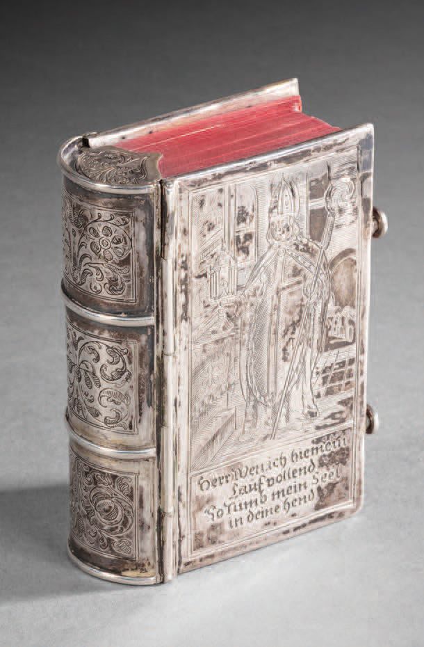 Null Engraved silver binding decorated on one side with a holy bishop holding a &hellip;