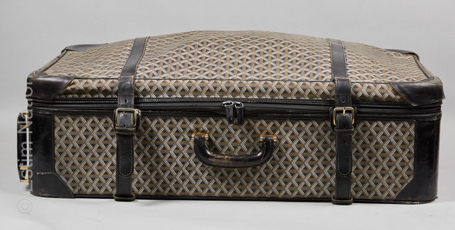 GOYARD goyardine和黑色皮革的滚轮旅行箱，帆布内部有一个大的拉链口袋和两条可调节的带子（50 x 80 x 22厘米）（拉链辫子在手柄附近脱落，帆&hellip;