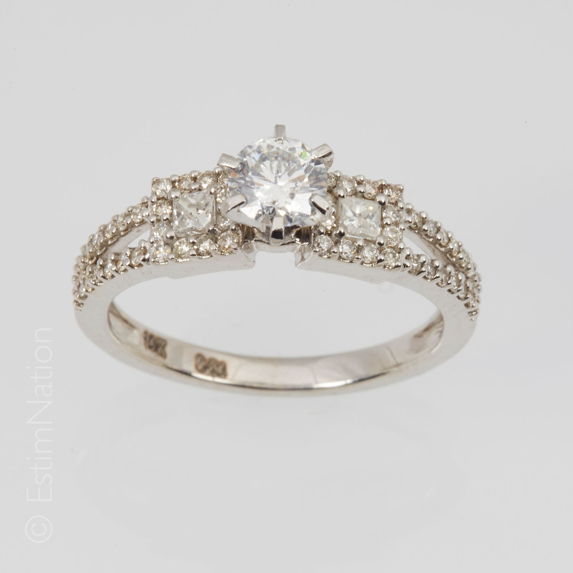 BAGUE DIAMANT 14K（585千分之一）白金戒指，镂空，镶有一颗0.50克拉的现代切割钻石，周围有两颗公主钻石和更小的钻石。手指大小：54.5。毛重&hellip;
