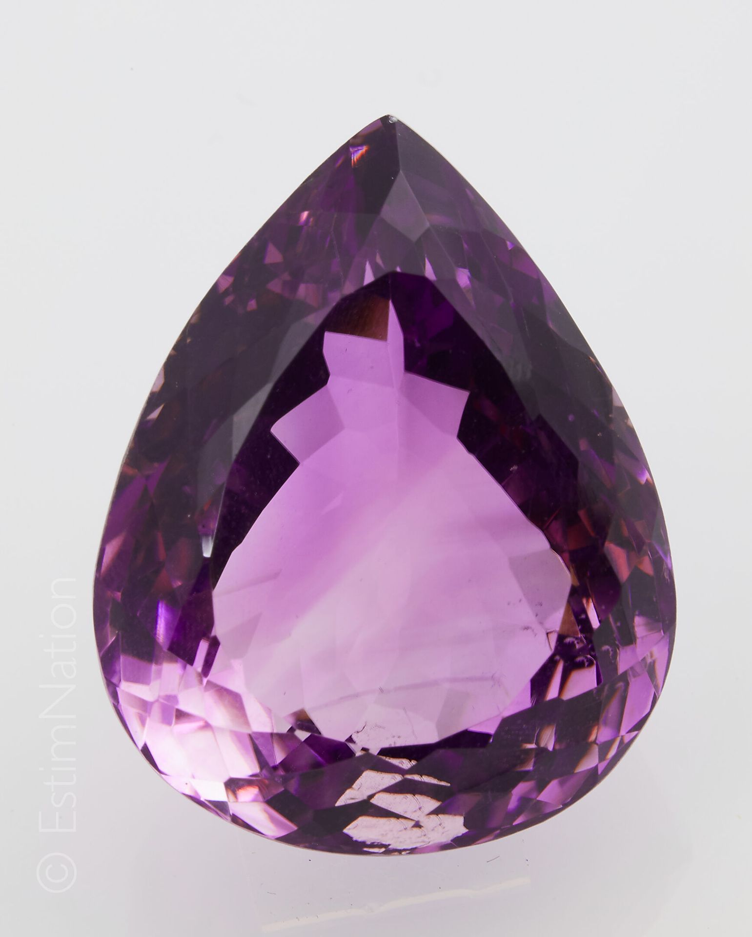 AMETHYSTE SUR PAPIER AVEC CERTIFICATS A large pear-shaped faceted amethyst on pa&hellip;