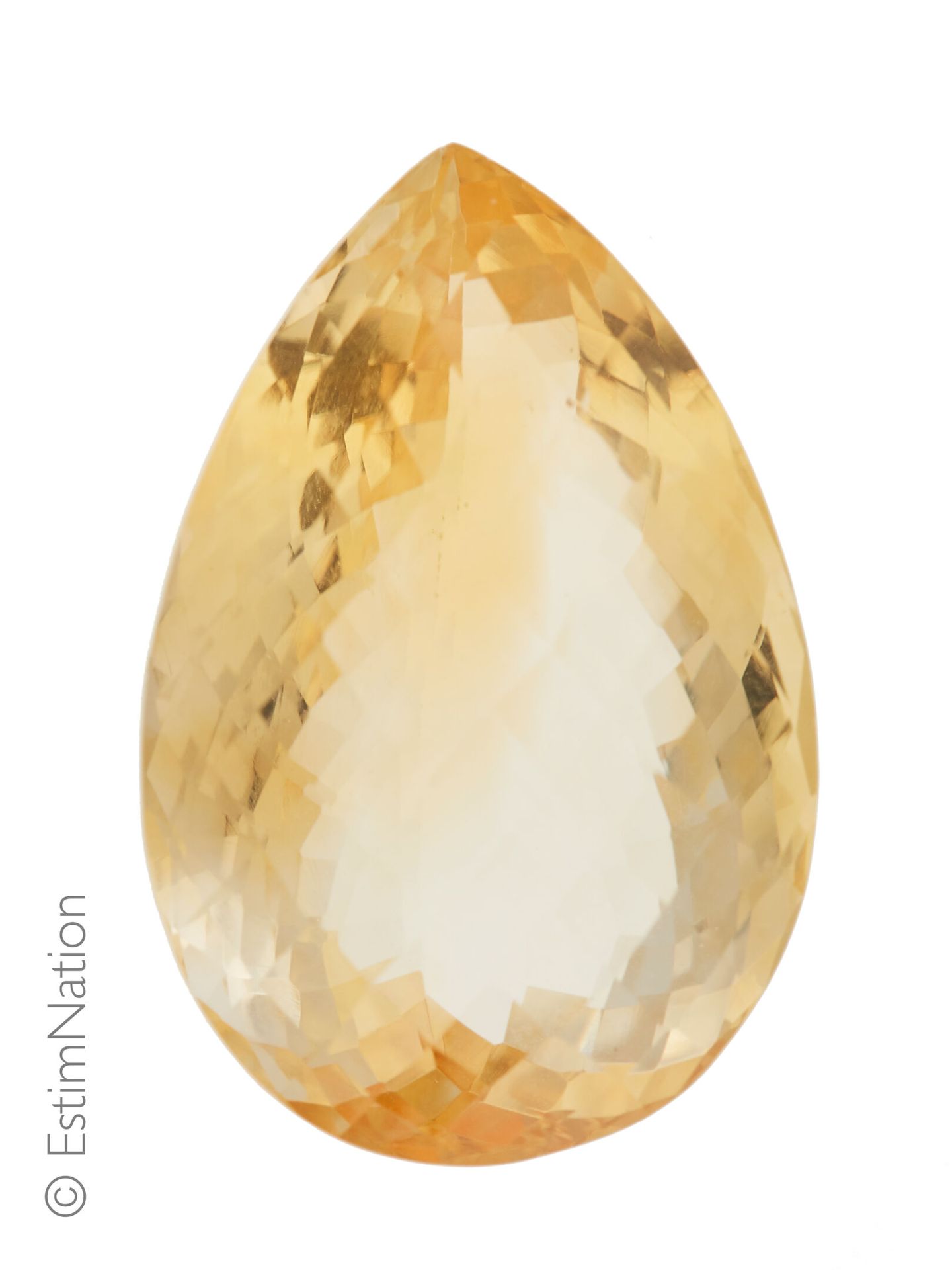 UNE CITRINE SUR PAPIER ET EXAMEN Une citrine sur papier de forme poire facettée.&hellip;