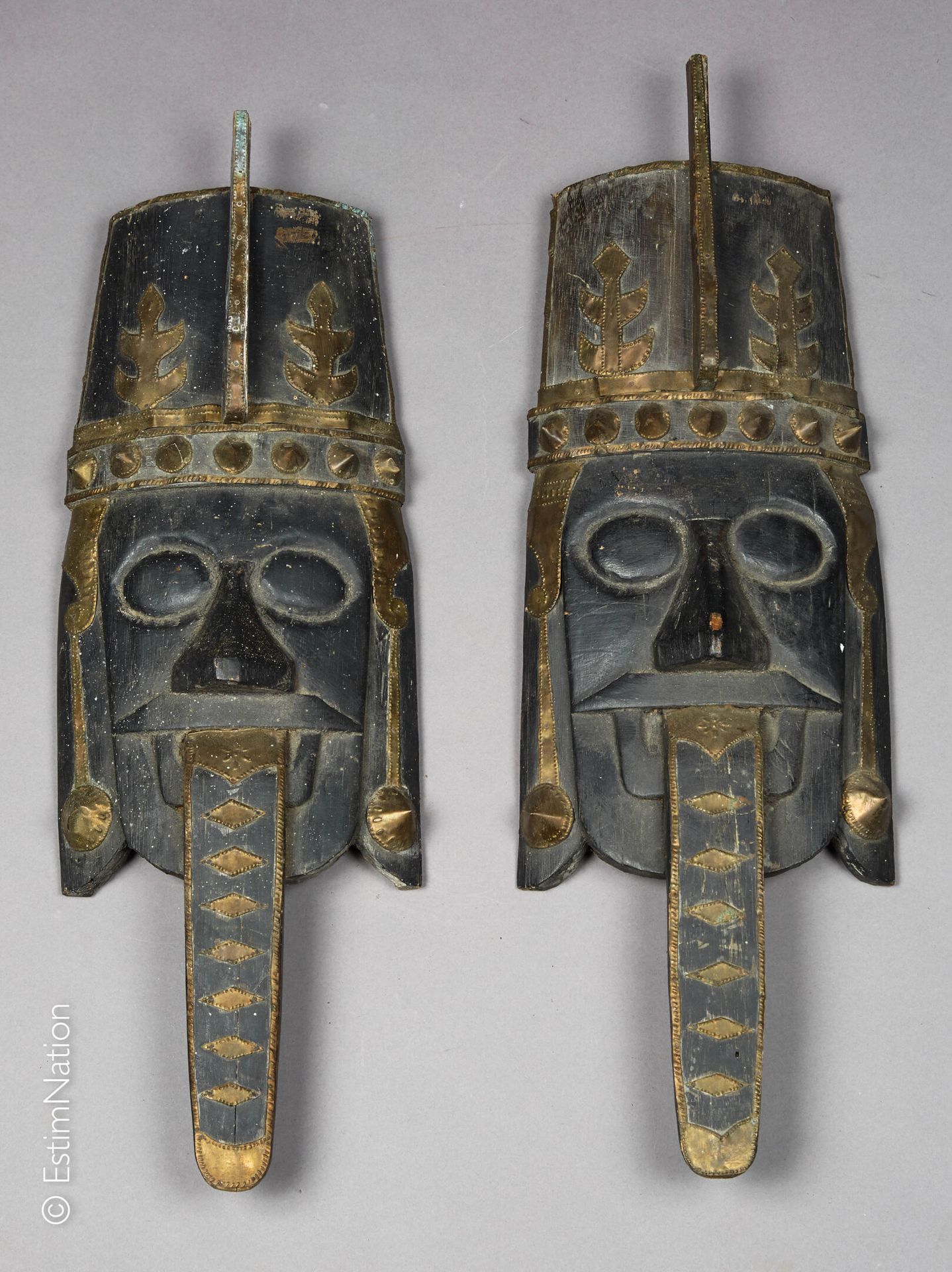 BORNEO KALIMANTAN 婆罗洲 - 加里曼丹岛



一对雕刻和铜化的木制面具，黄铜装饰的面具上有戴头盔的人的脸，他们的舌头悬在外面。



高度：&hellip;