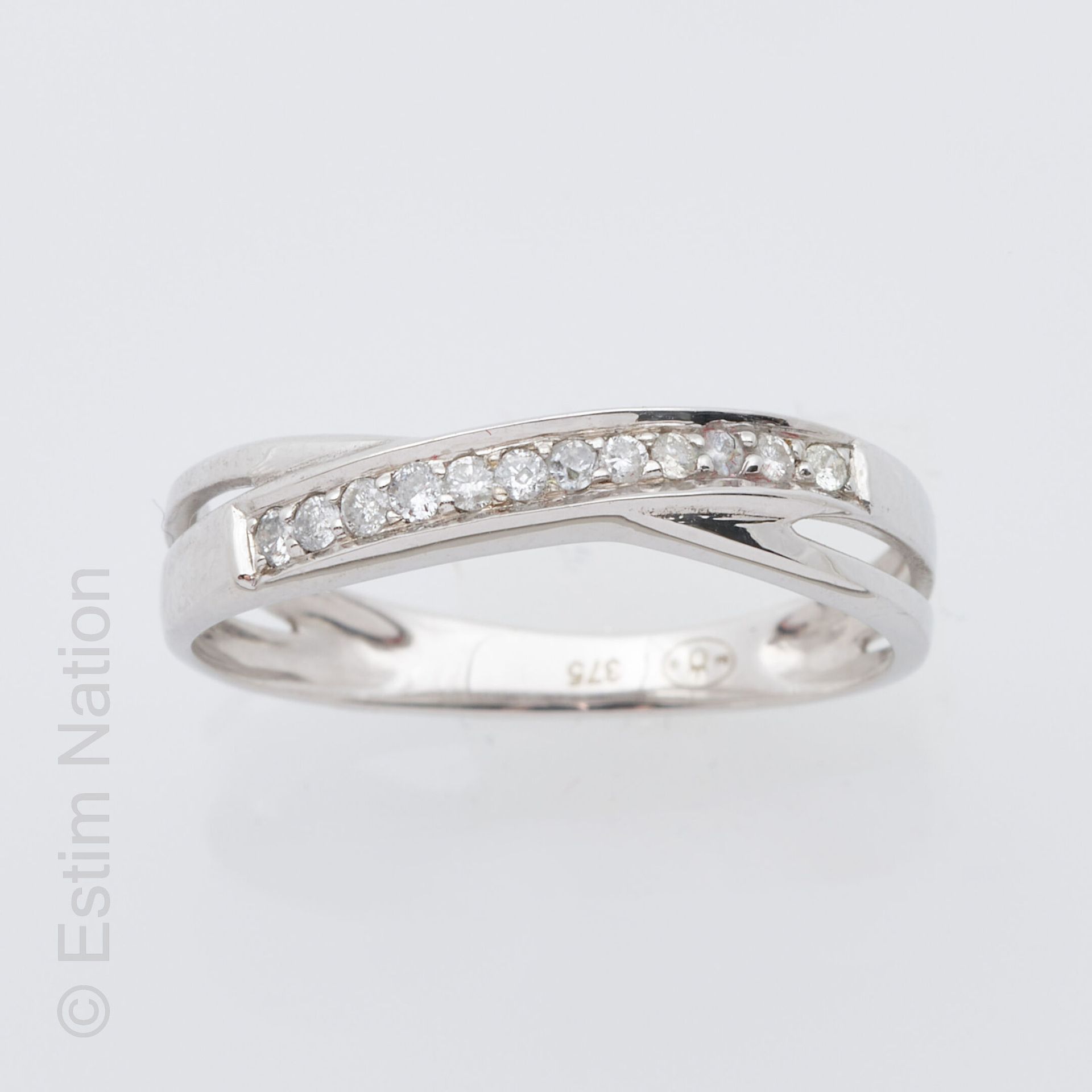 ANNEAU OR GRIS ET DIAMANTS 9K白金（千分之三十五）戒指，交叉图案，饰有一排刻面白色宝石。手指周长：51.5。毛重：1.4克。