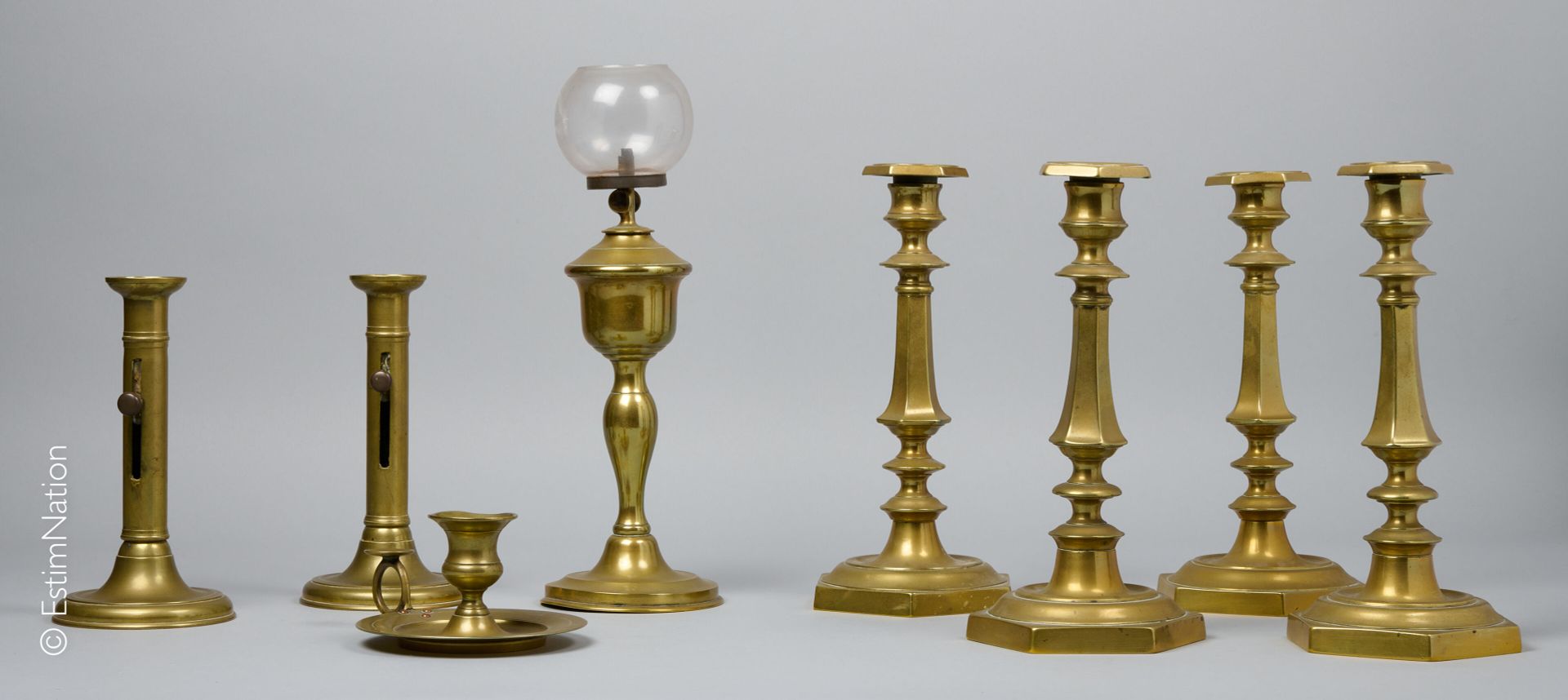 DINANDERIE Set including : 
- Suite of four brass candlesticks, the baluster sha&hellip;