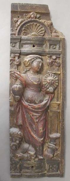 Null 多色低浮雕木板，描绘了一个女人拿着一颗心和代表太阳的奖章，在她脚下压着一个男人，建筑环境中还有贝壳和小天使。

可能是西班牙，17世纪初。

68,5&hellip;