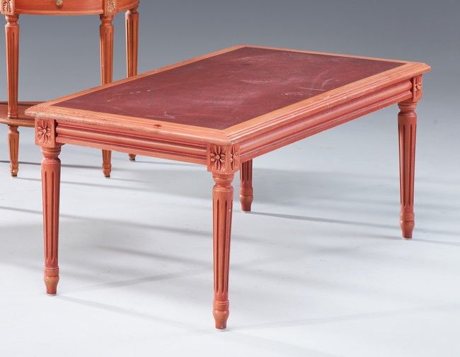Null 橙色漆木的长方形矮桌，木质桌面仿红色皮革，靠在四个有凹槽的锥形腿上。

路易十六风格

高45厘米；长104厘米；深55厘米

(使用后的划痕)