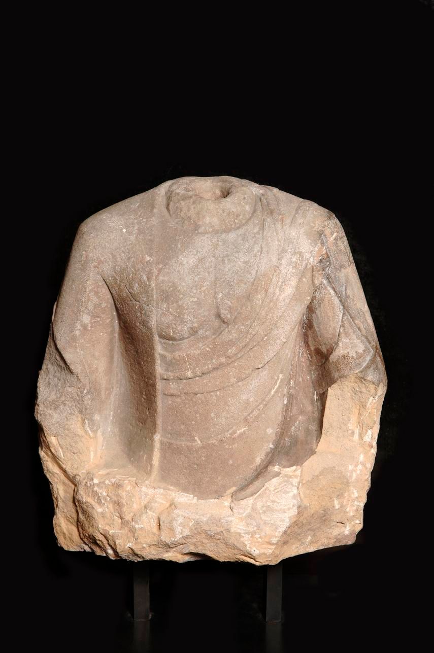 Null Acephalous sandstone bust of Buddha revealing the pleated drape. China, Tan&hellip;