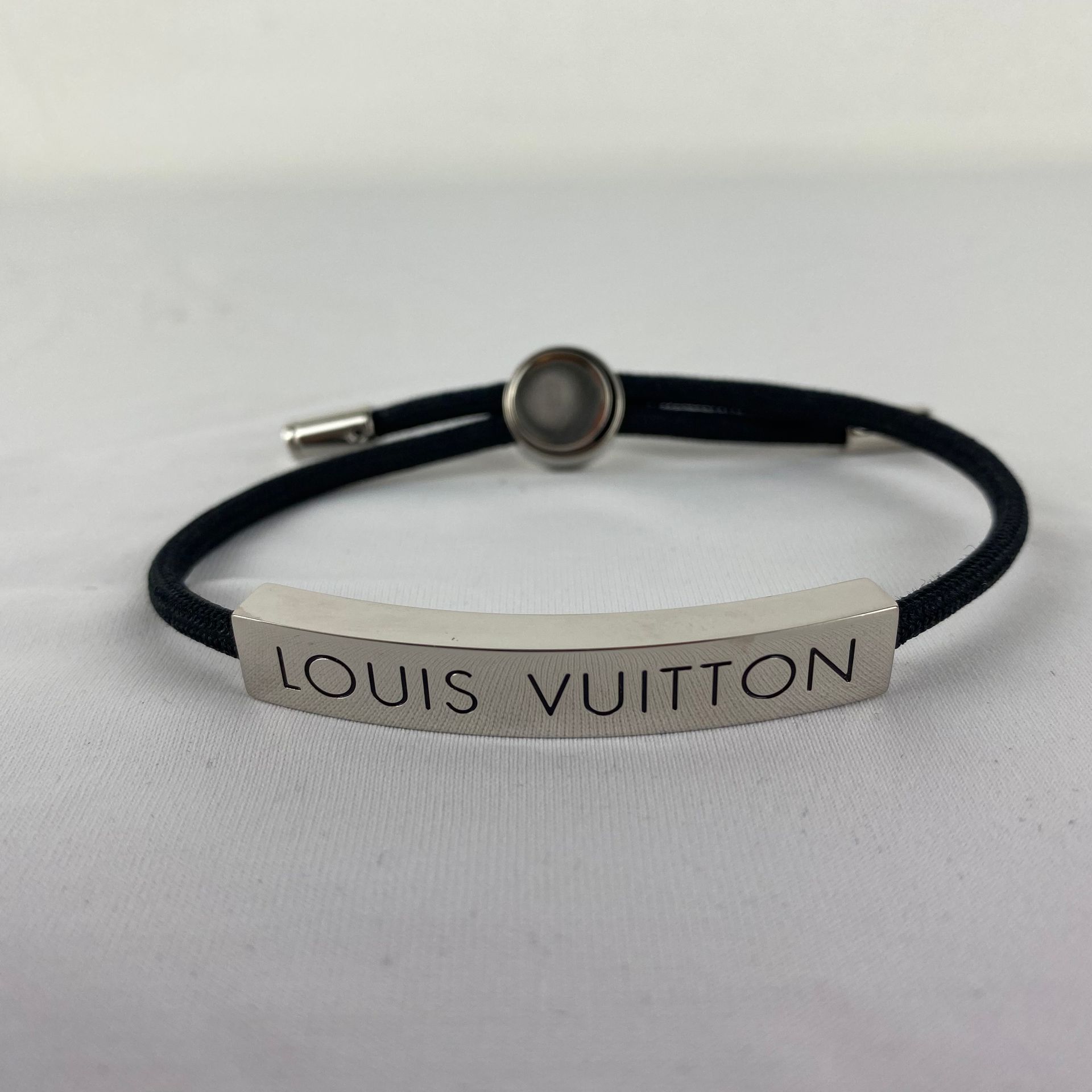 LOUIS VUITTON A LOUIS VUITTON bracelet model LV Space black adjustable cord with&hellip;