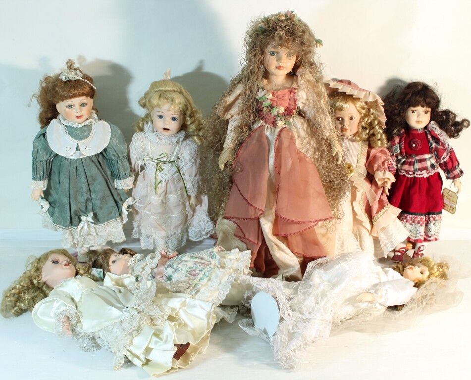 Null Set of 8 porcelain head dolls.