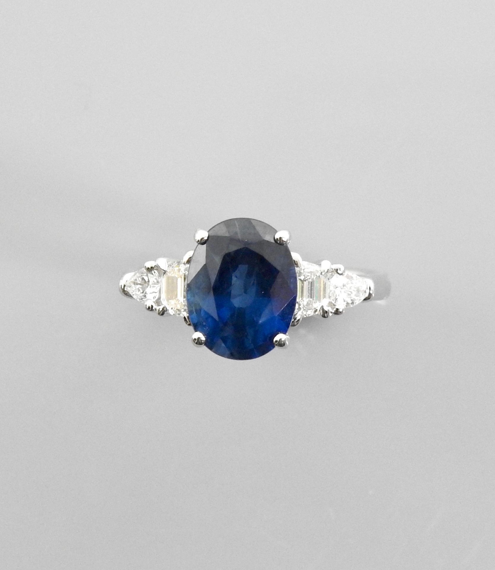 Null 白金戒指，750毫米，镶有一颗重3.60克拉的椭圆形蓝宝石和四颗钻石，共重约0.60克拉，尺寸：54，重量：4.65克，毛重。