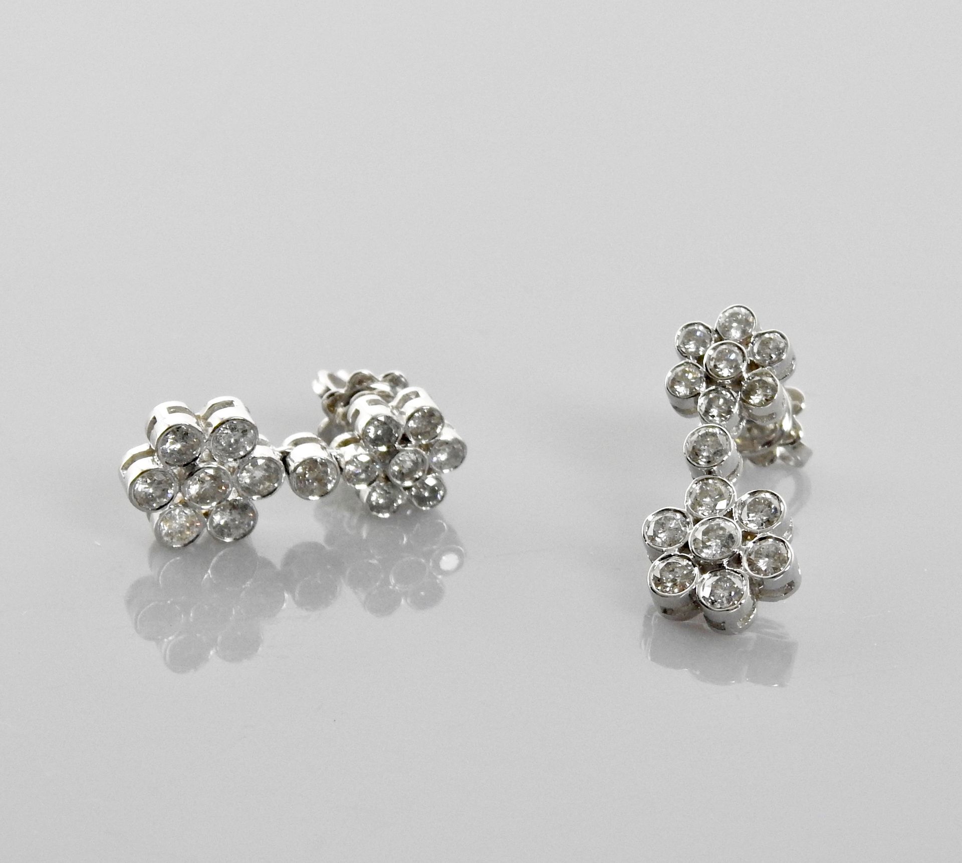 Null 白金耳环，750毫米，每只耳环上都绘有两朵布满钻石的花朵，共1.40克拉，长23毫米，重量：5.7克。