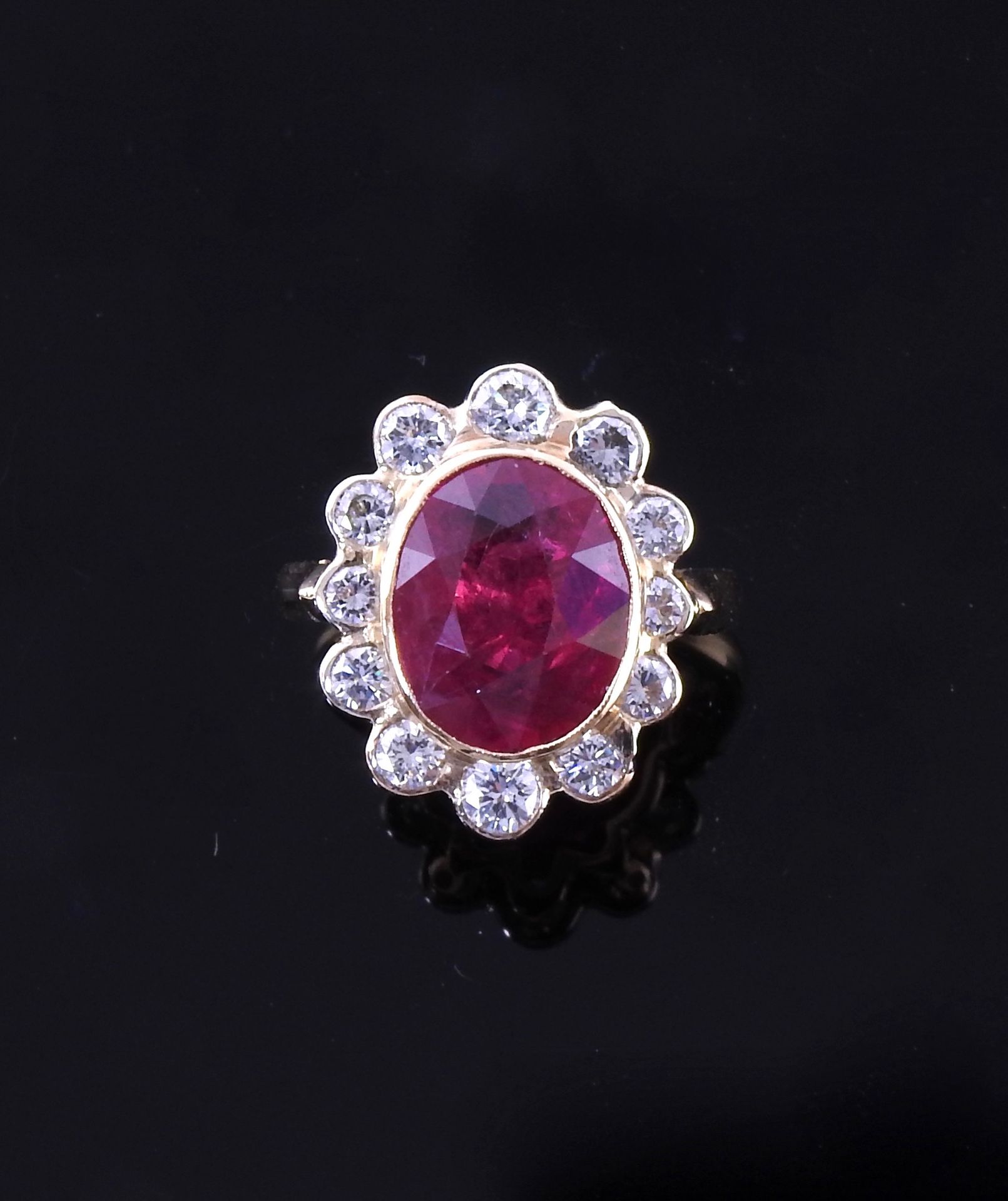 Null 
Flat ring in white and yellow gold, 750 MM, centered on an oval ruby weigh&hellip;
