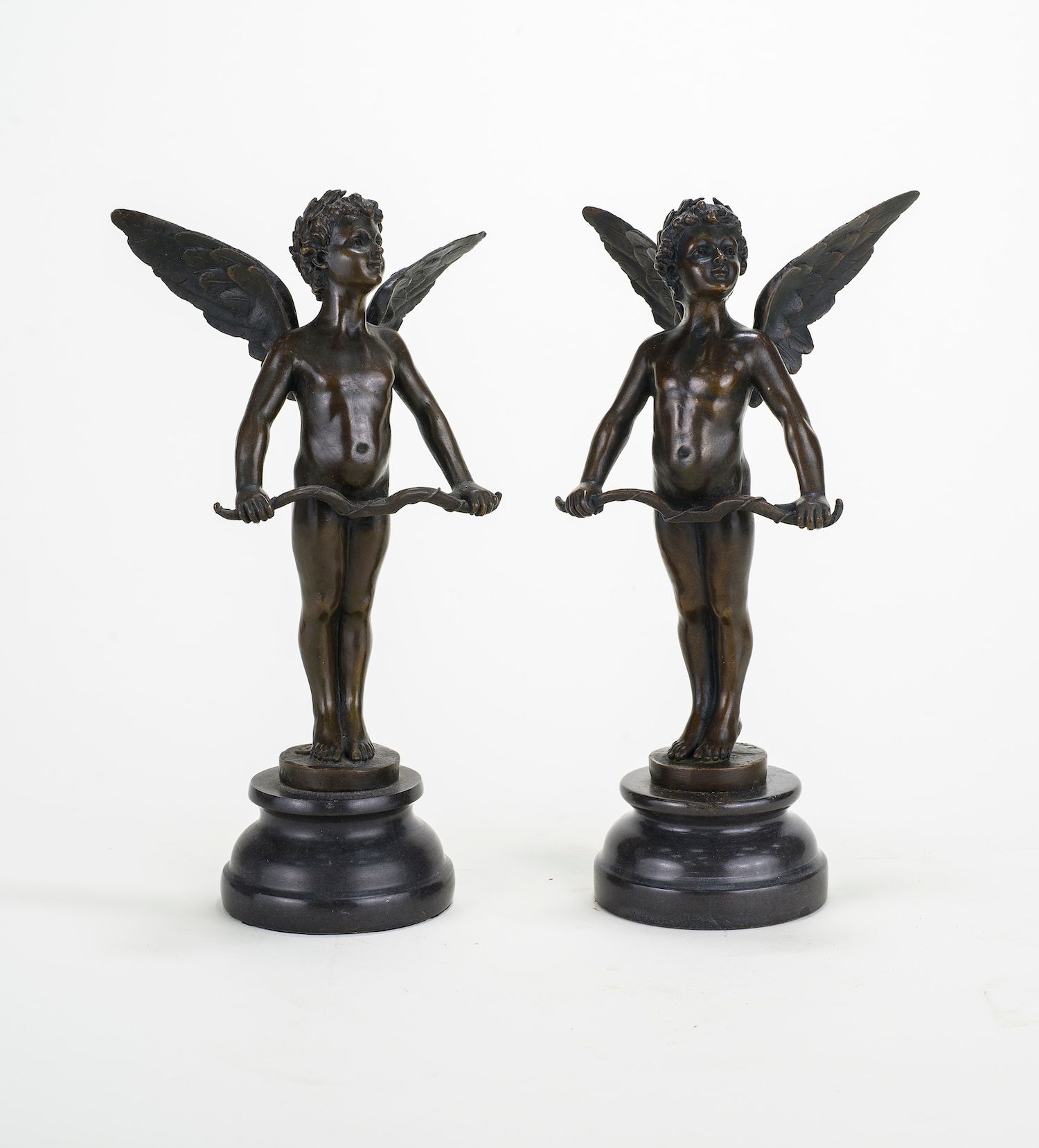 Null Two statuettes of putto

Bronze with brown patina 

Black marble base 

Hei&hellip;