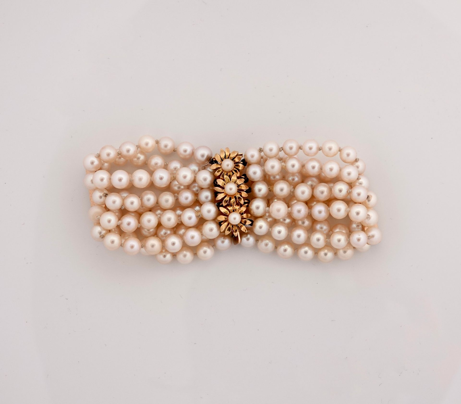 Null 由五排养殖珍珠组成的手镯，直径为5/5.5毫米，有黄金花饰的扣子，750毫米，长20厘米，重量：50克。