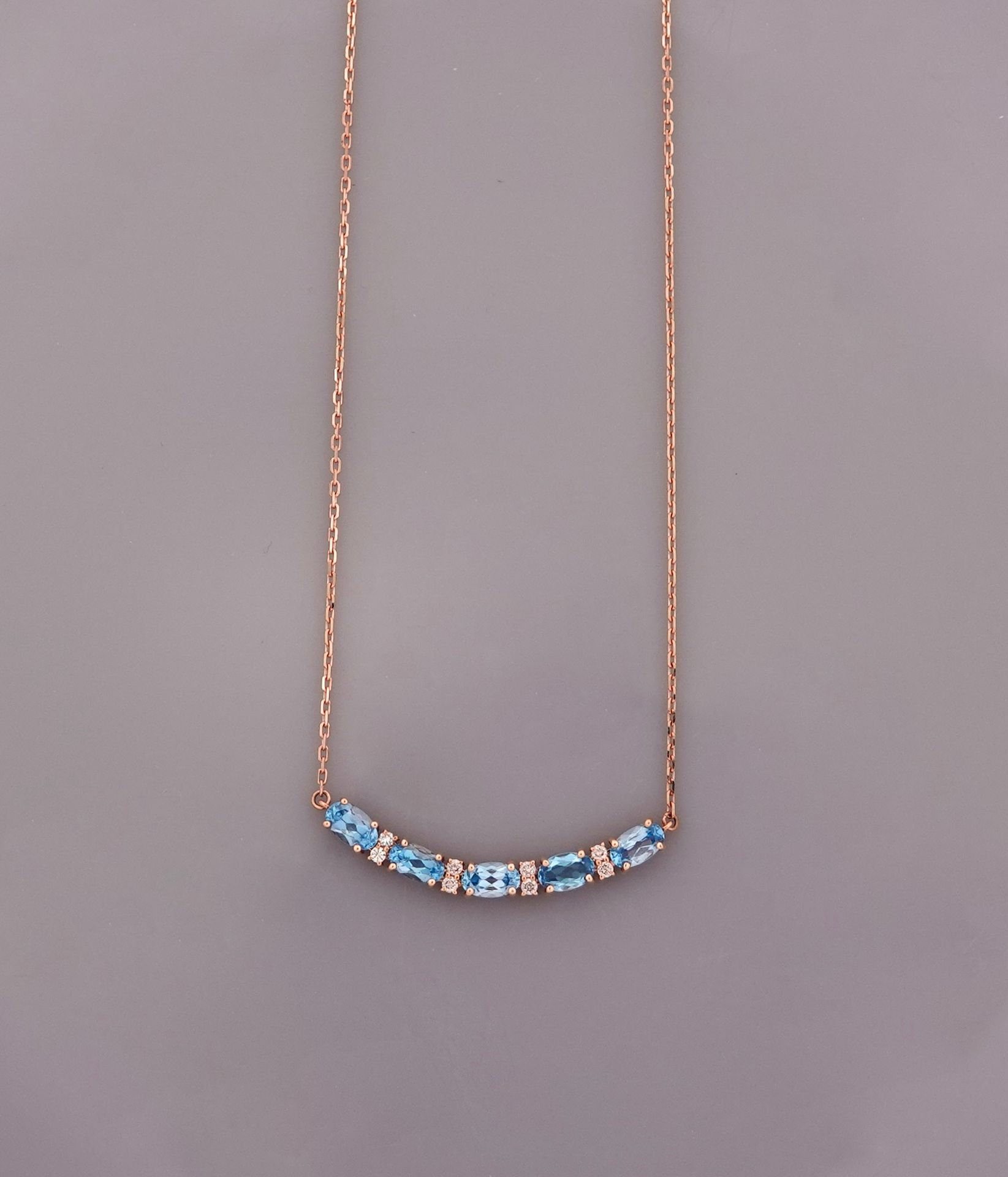 Null Pink gold necklace, 750 MM, centered with five oval blue topazes interspers&hellip;