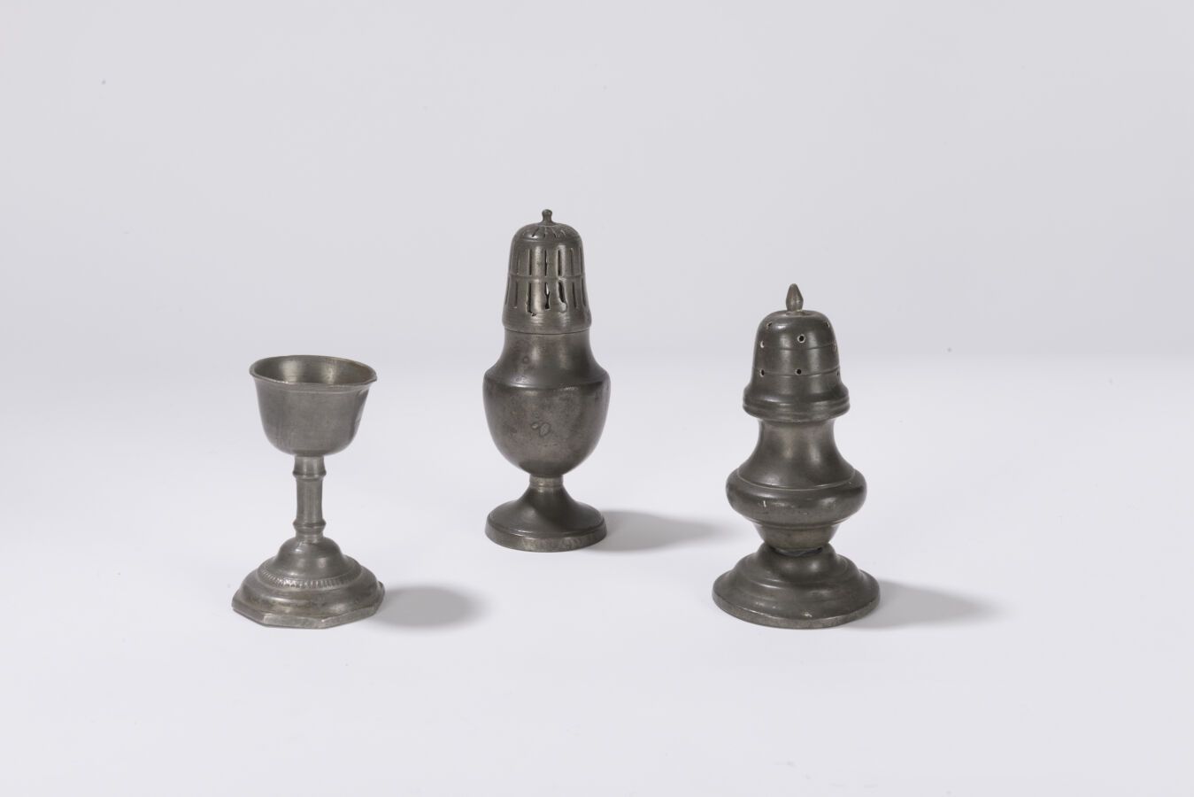 Null Two baluster sprinklers and an egg cup, early 19th century.
