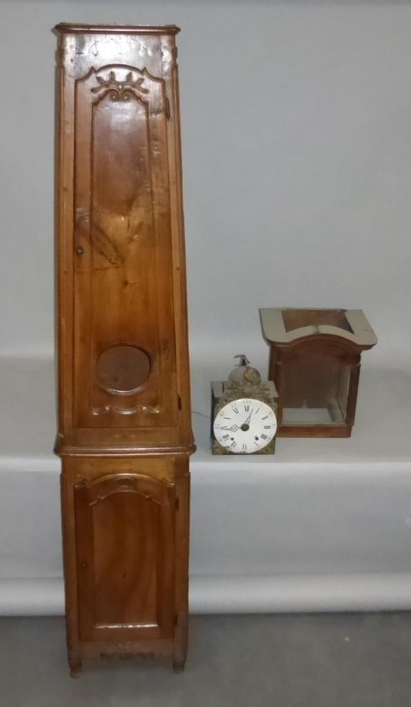 Null 
A large carved walnut floor clock inlaid with a flowering vase (in three p&hellip;