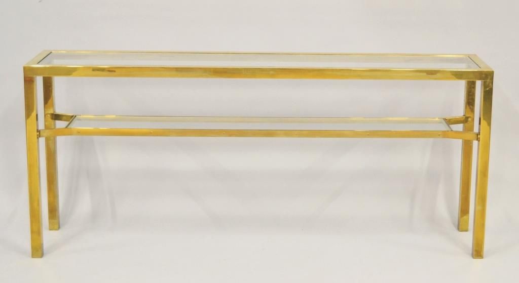 Null Console en métal doré à deux plateaux en verre.

H. 75 L. 175 P. 36 cm