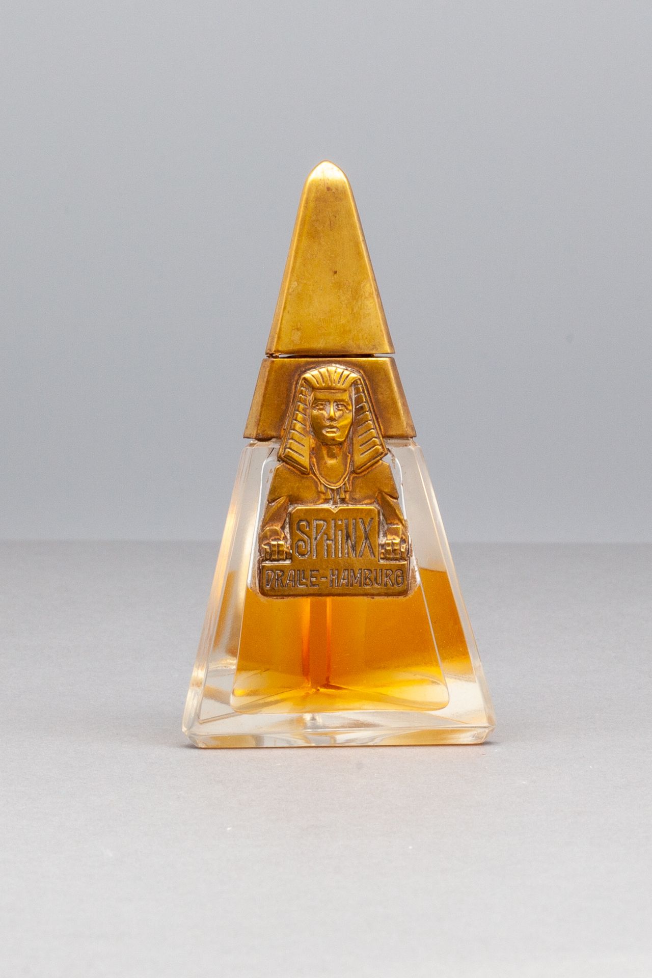 DRALLE "SPHINX" Bottle of pyramidal shape out of glass. Metal label titled "SPHI&hellip;