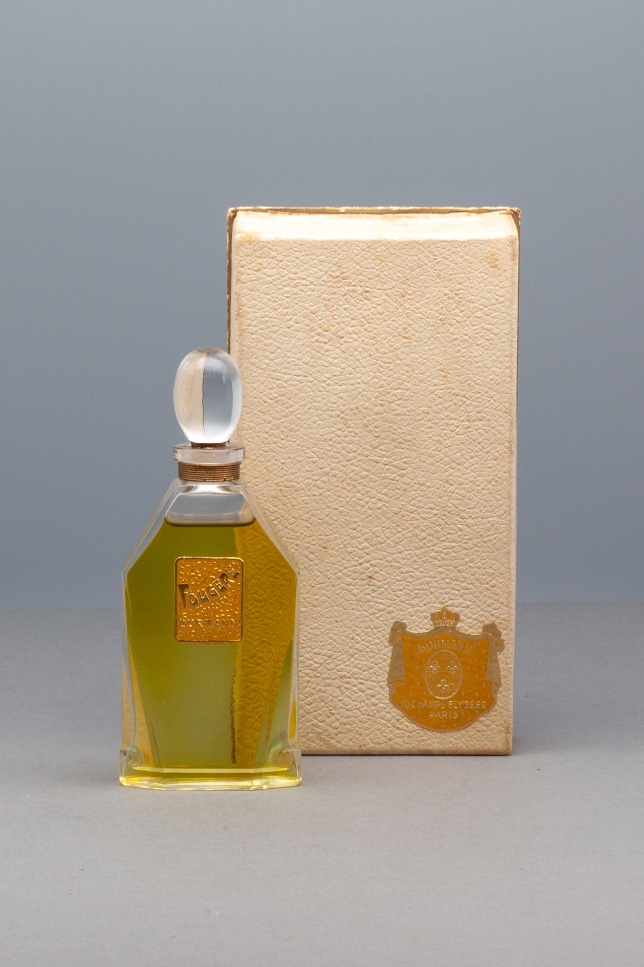 BURMANN "FOUGERE" 密封的香水瓶，上面有说明的标签。橄榄形的塞子。在它的盒子里，装饰着它的标题标签。高12.5厘米 - 盒子尺寸16x8.5厘米